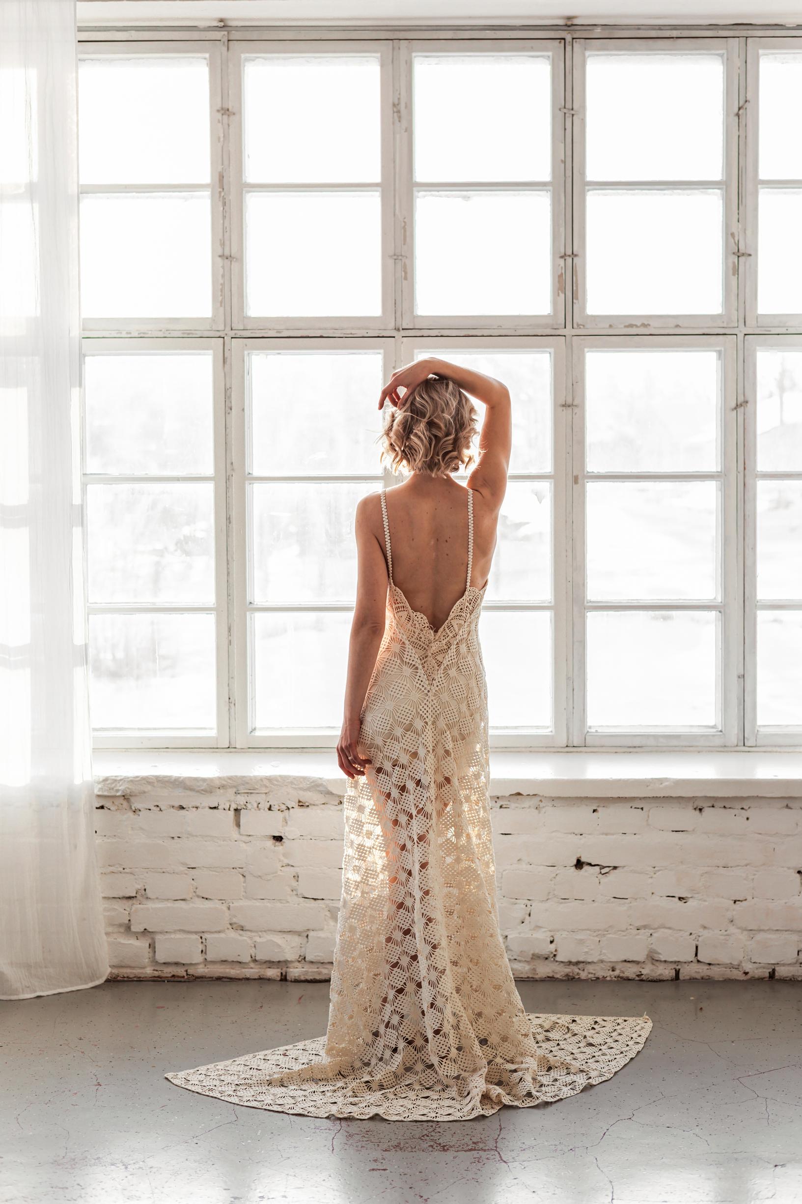 A lace wedding gown worn by a model.