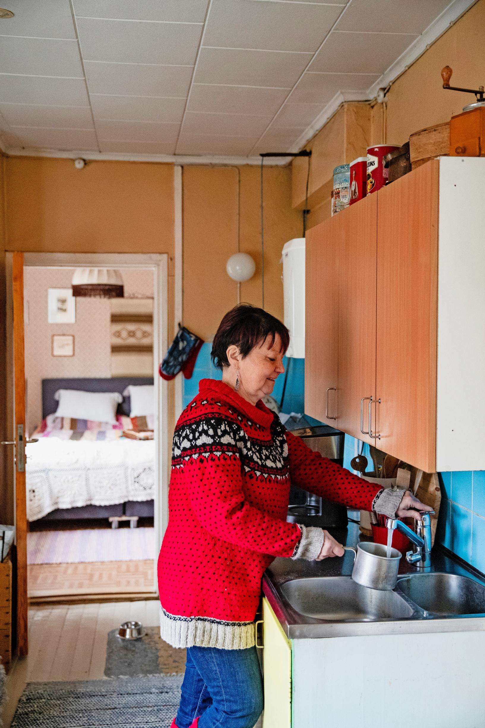 Päivi in the house’s kitchen.