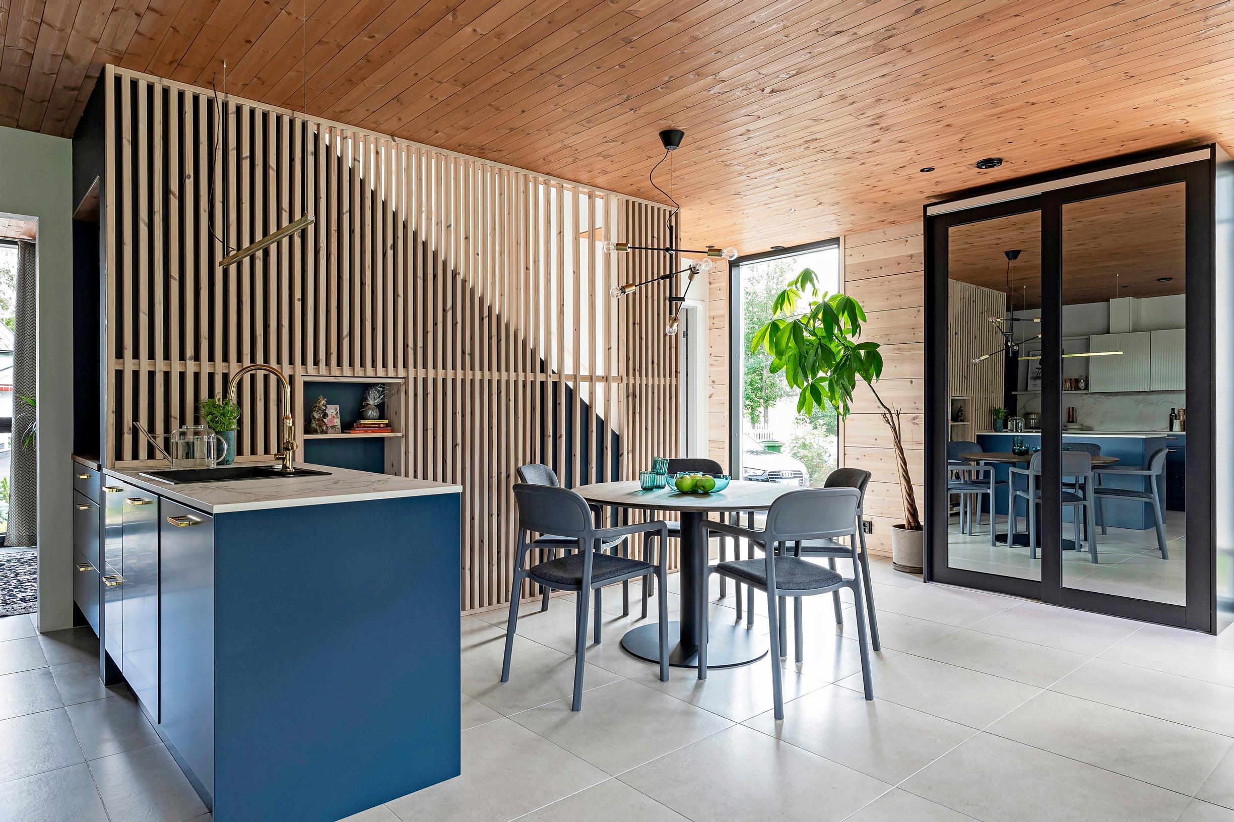 A slatted wall functioning as a stair railing