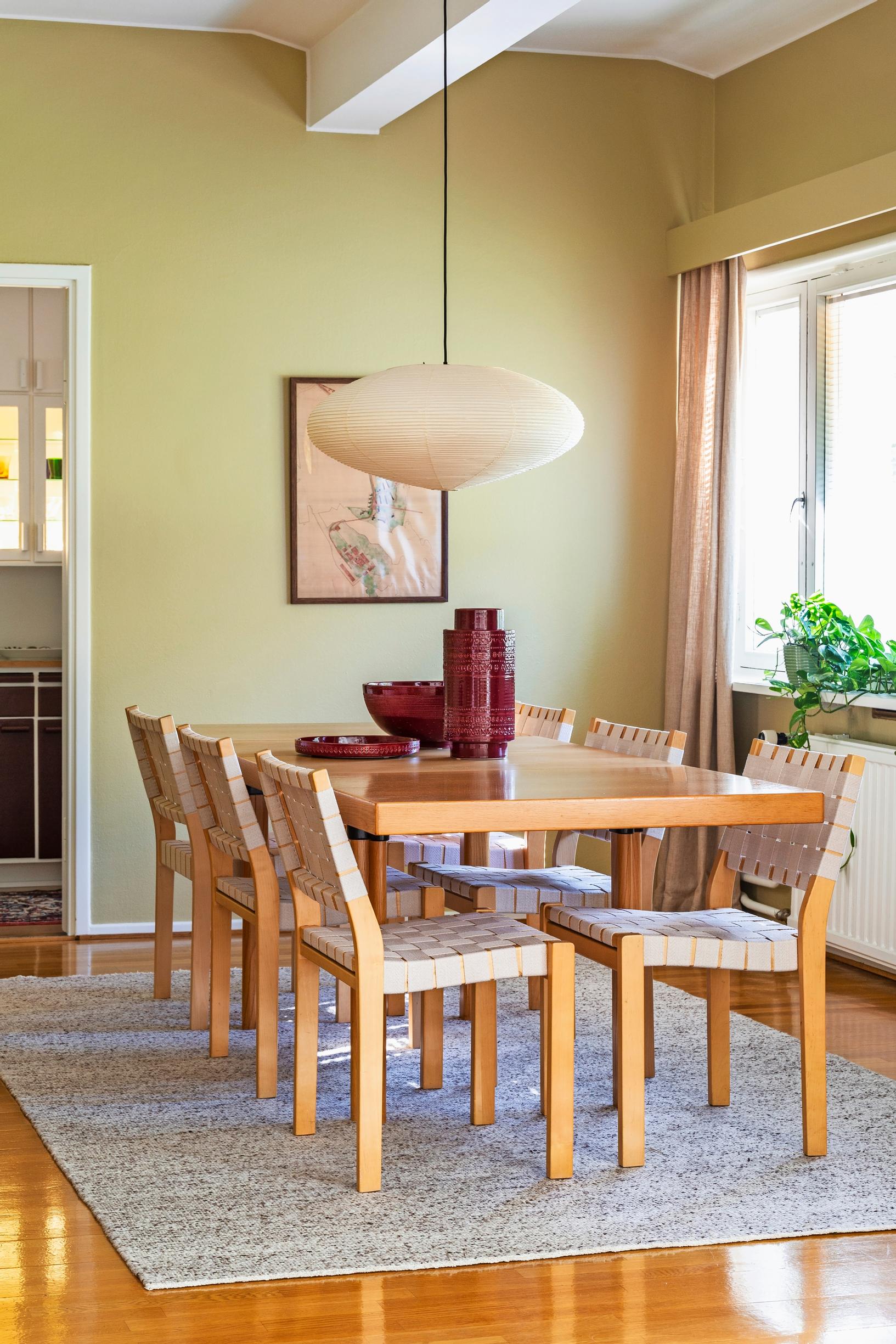 Alvar Aalto’s H92 oak table and saddle-strap 611 chairs in the dining area