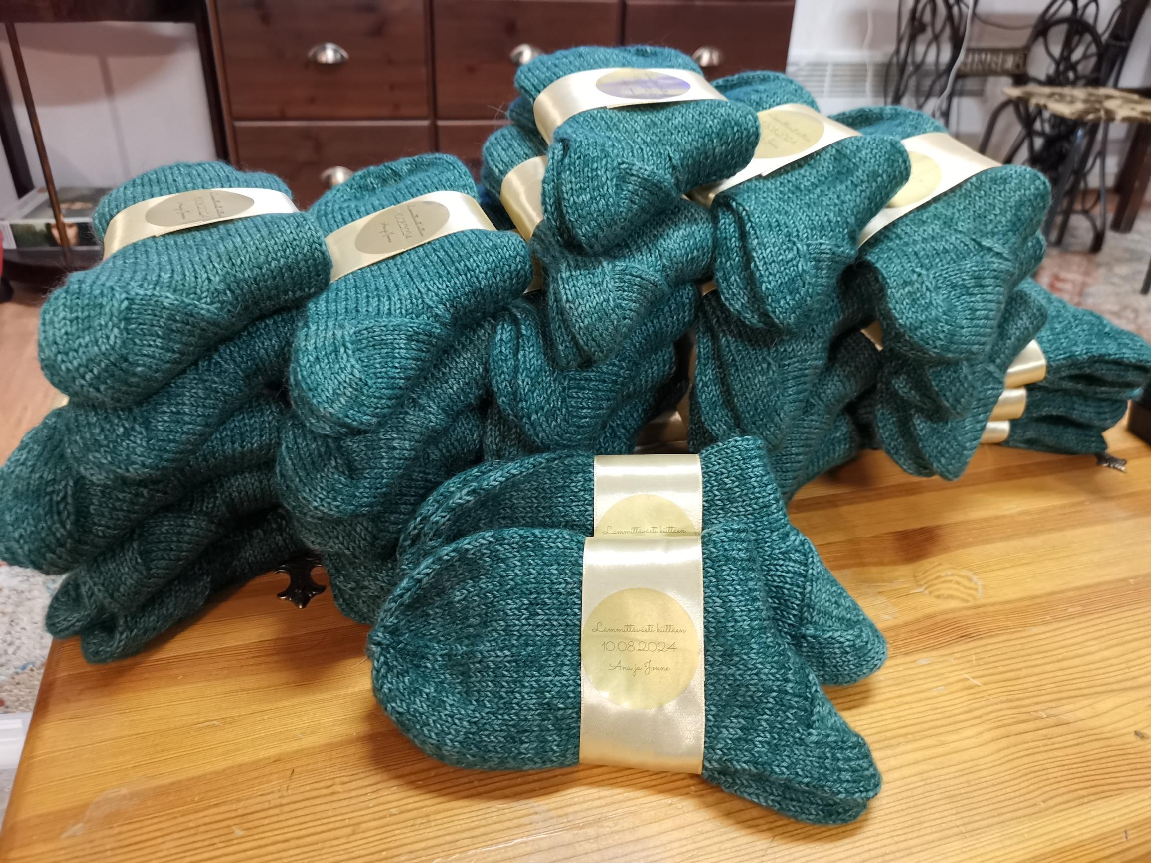 Dozens of packaged wool socks ready for the wedding