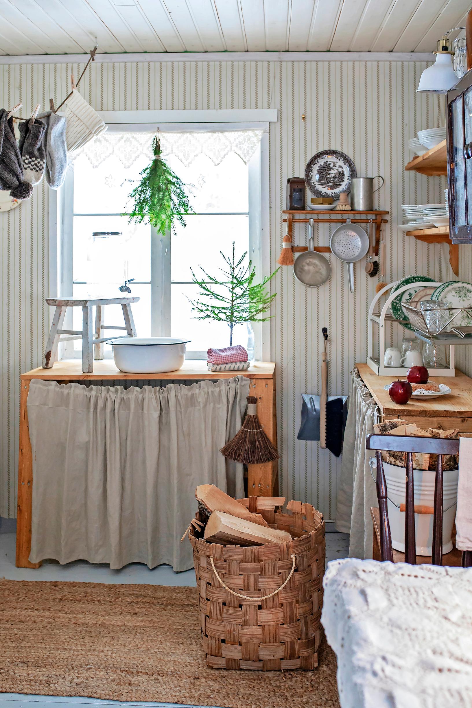 In the cottage kitchen, a firewood box and other items.