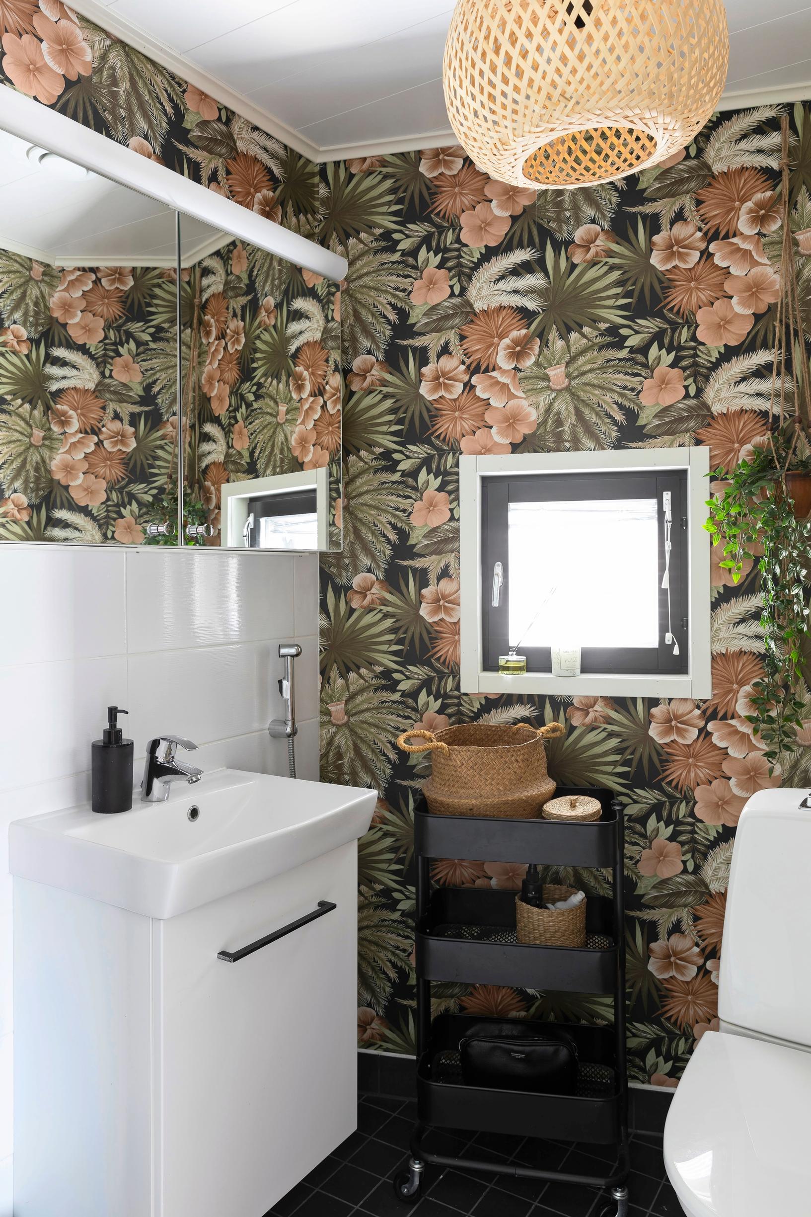 The bathroom now has floral wallpaper.