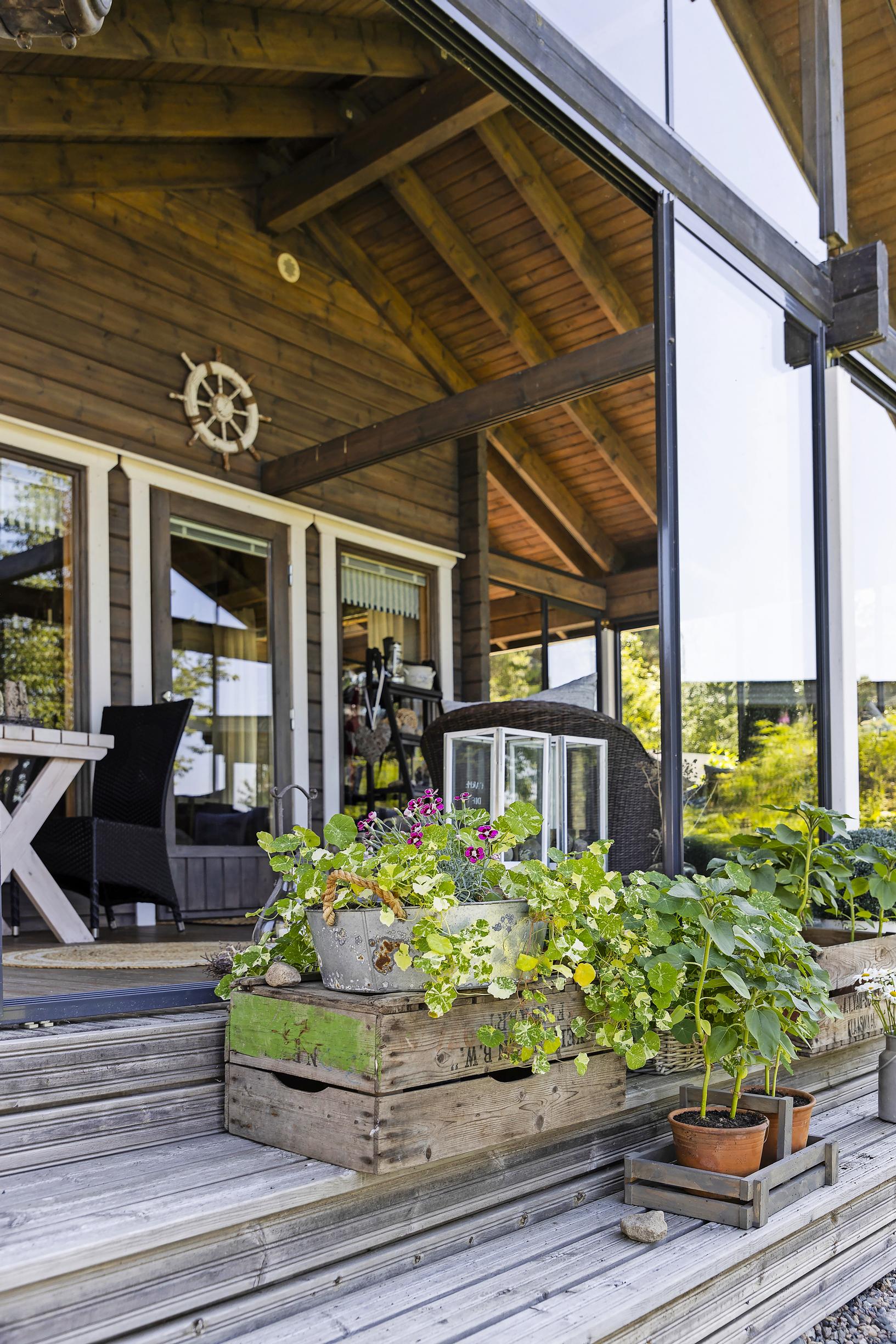 The terrace of Marita and Eki’s island cottage with various planter boxes