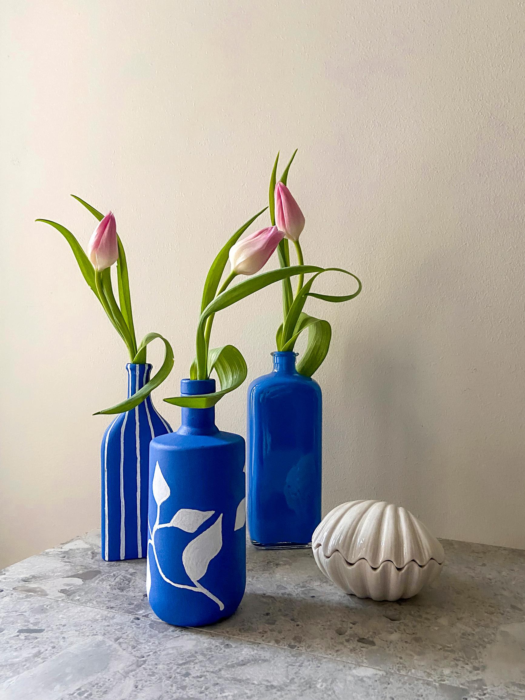 Glass bottles painted in blue