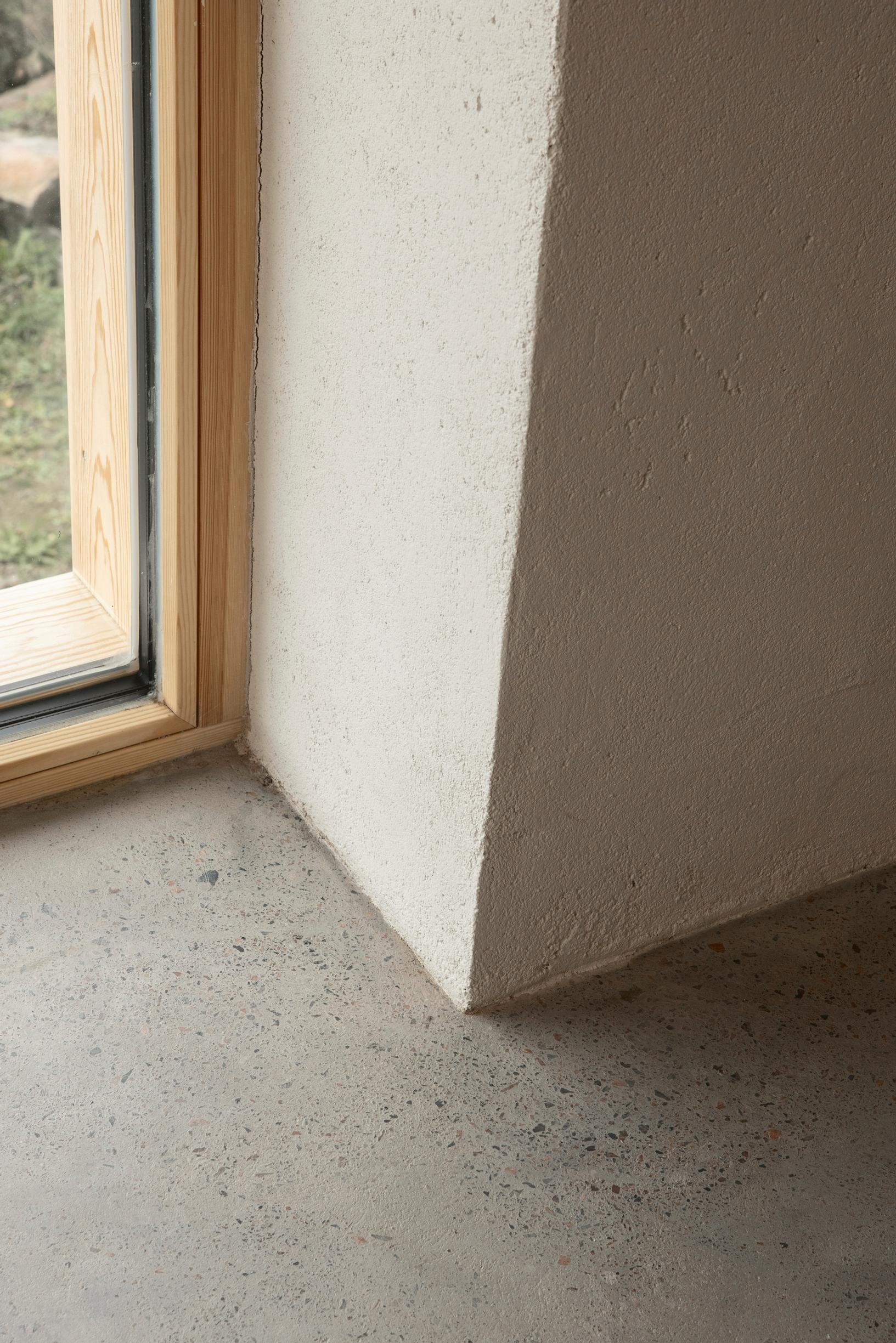 Window frames partially embedded in wall and floor structures