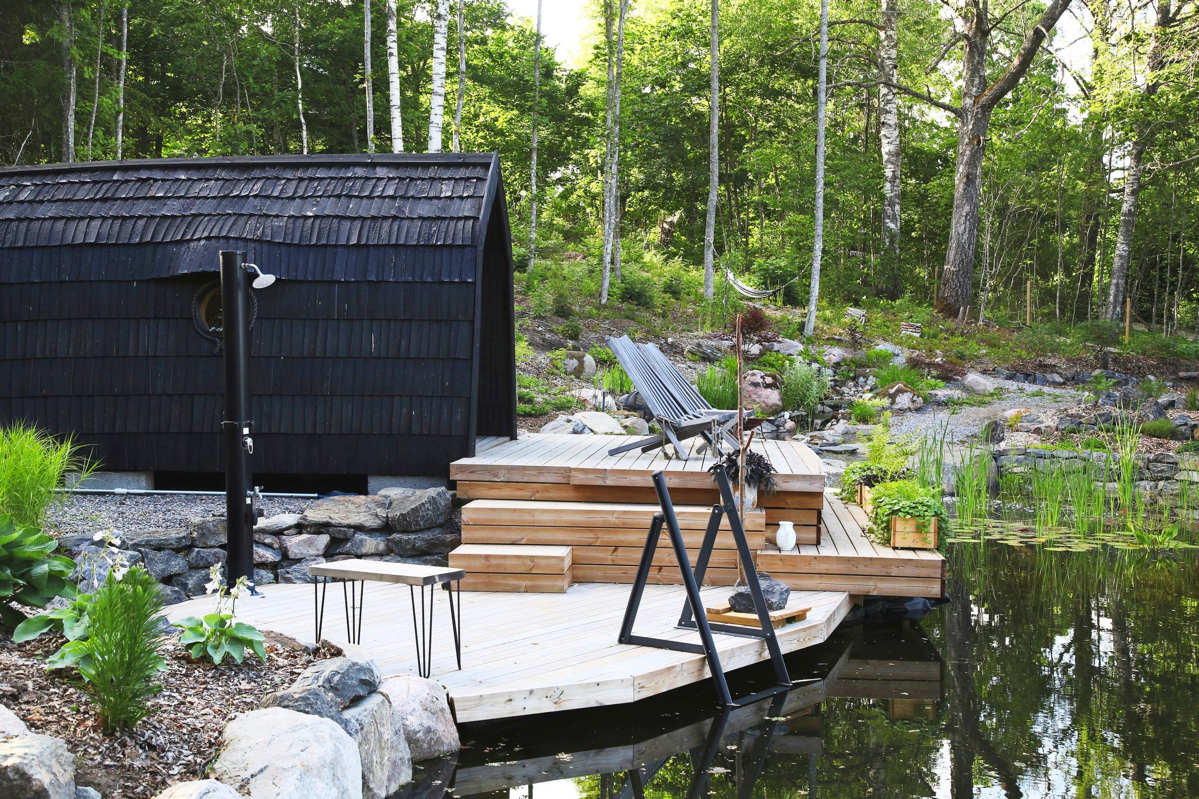 A swimming pond in the yard of a single-family home