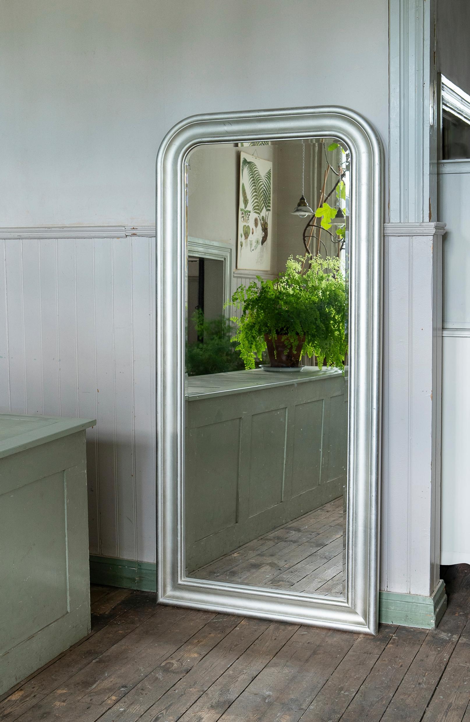 A metallic-finish mirror before the makeover.