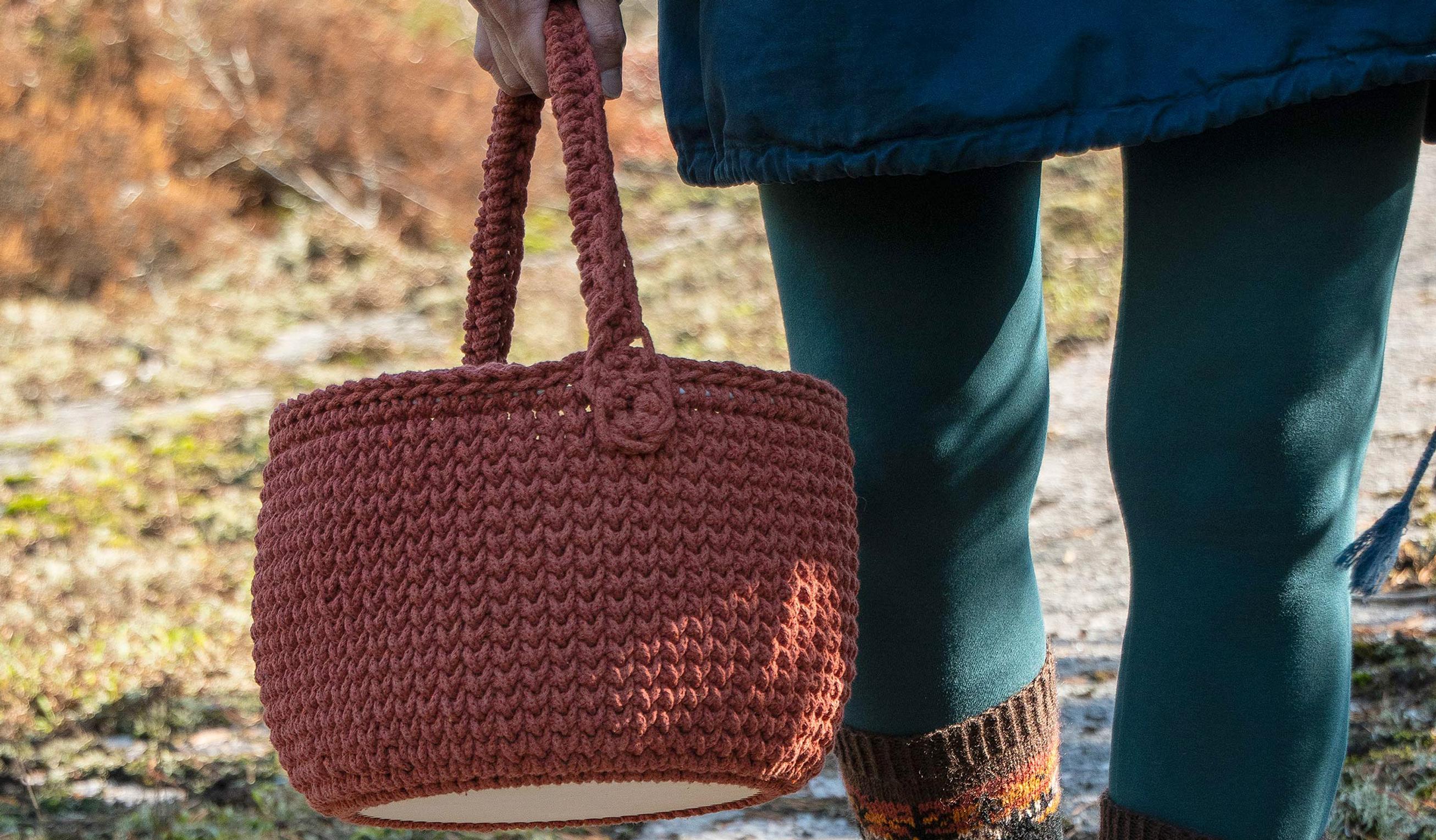 Crocheted picnic basket with a sturdy handle and plywood base—make it and take it anywhere!