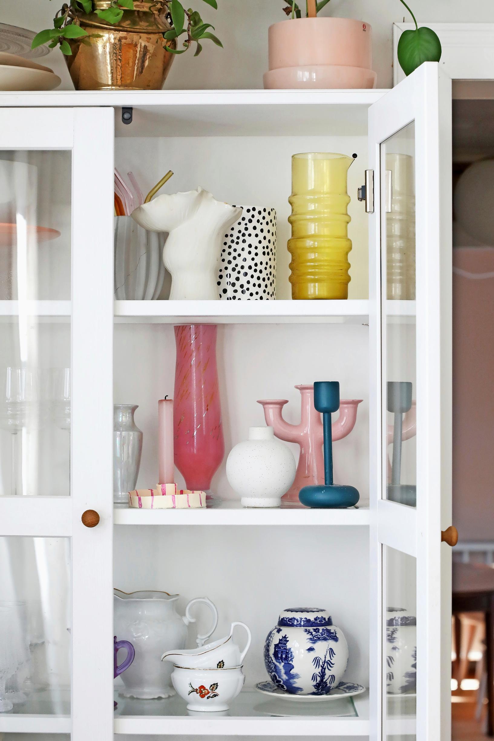 a display cabinet with colorful dishes