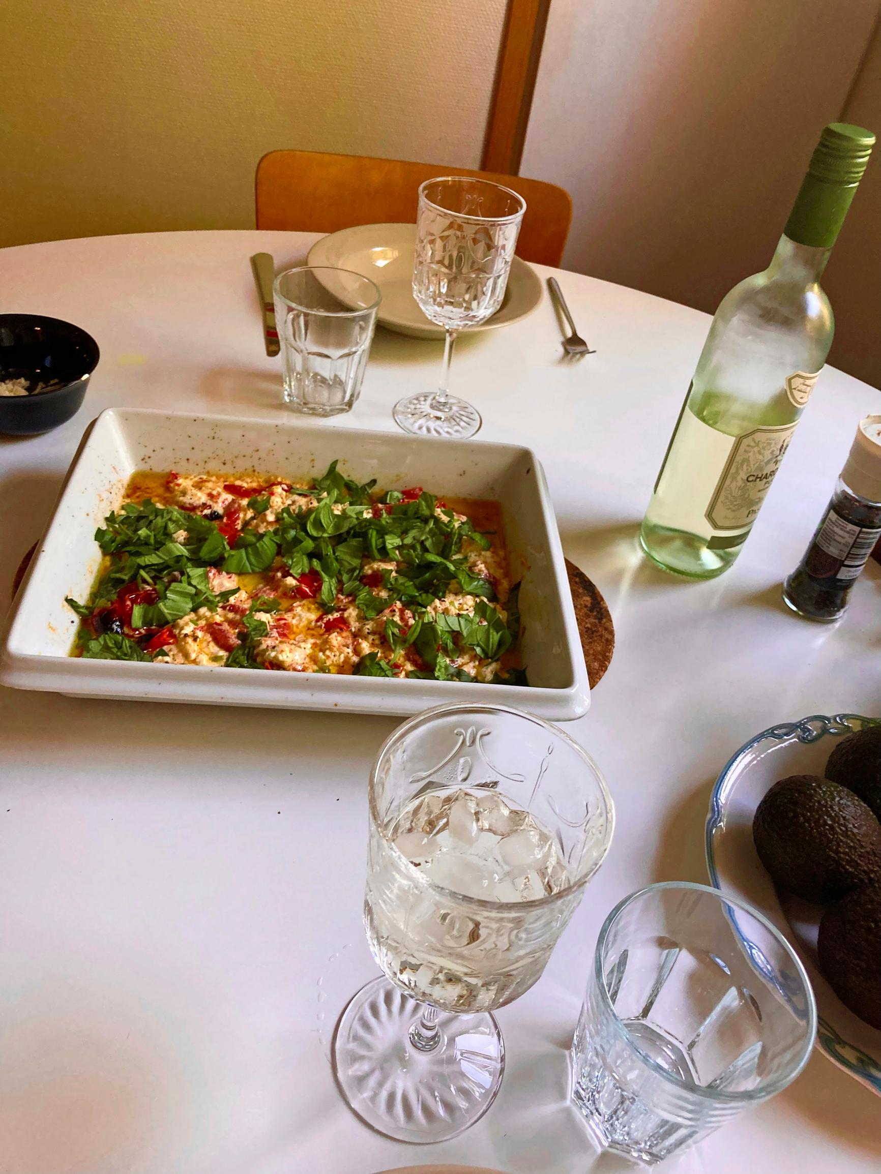 a set table with oven-baked feta pasta and wine