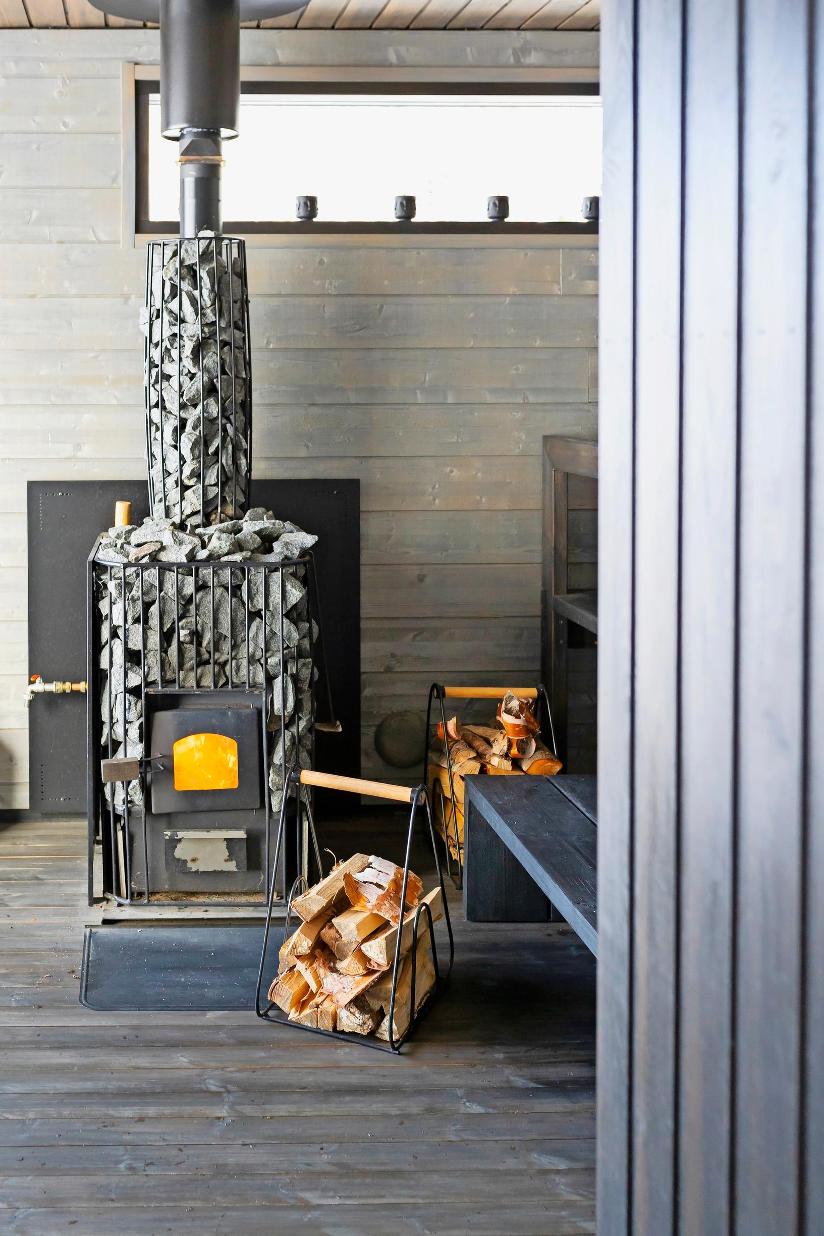Modern stove and log holder in the sauna
