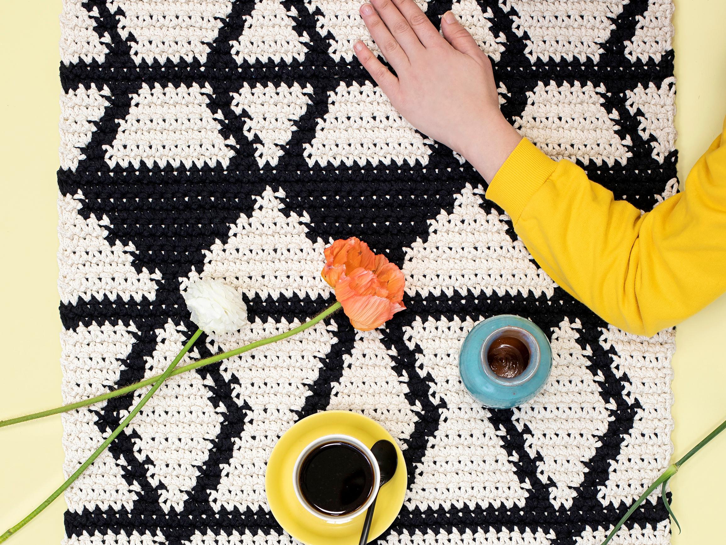 This long and narrow crocheted rug is perfect for your kitchen or entryway—follow the simple graphic pattern