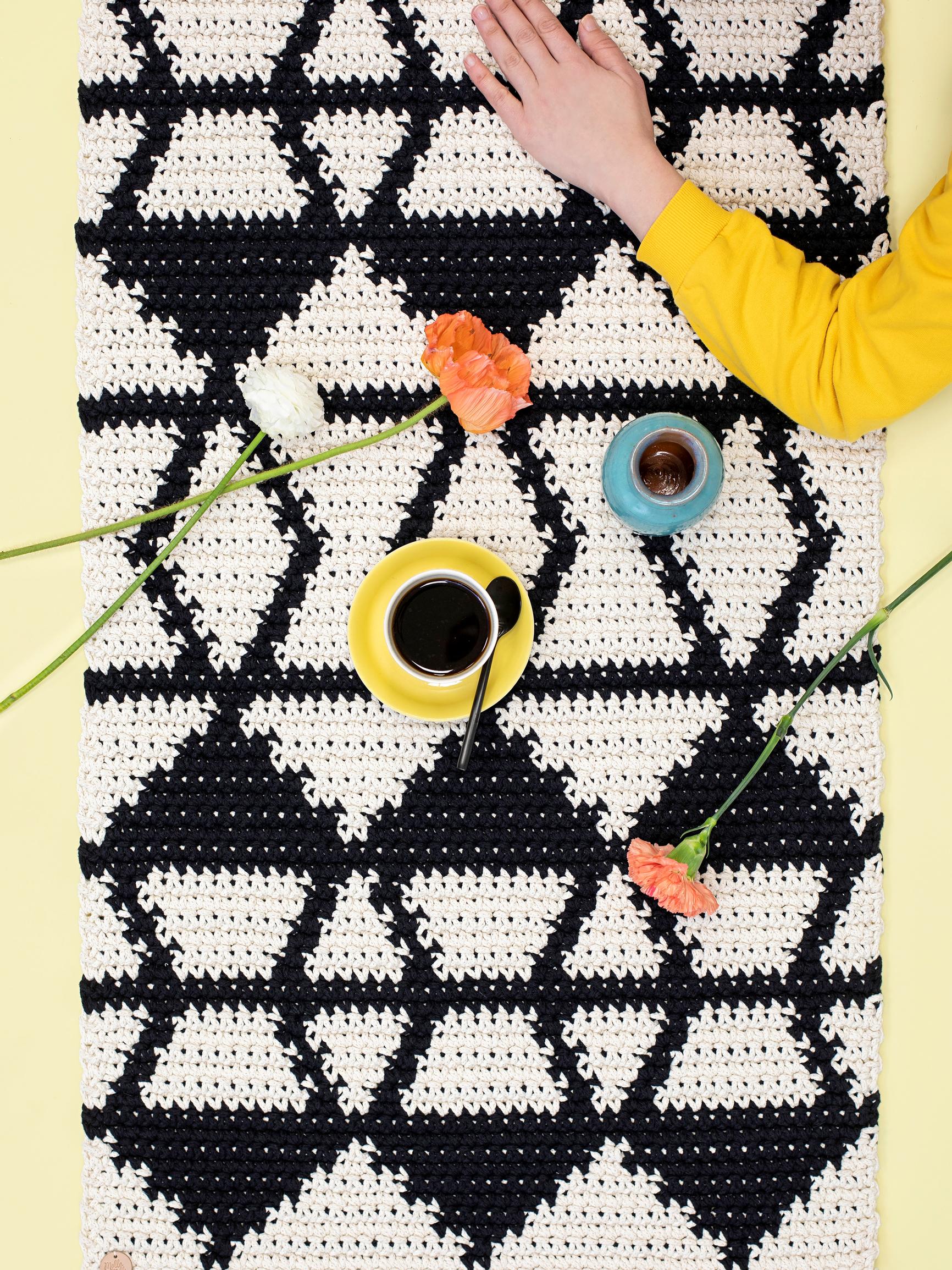 This long and narrow crocheted rug is perfect for your kitchen or entryway—follow the simple graphic pattern