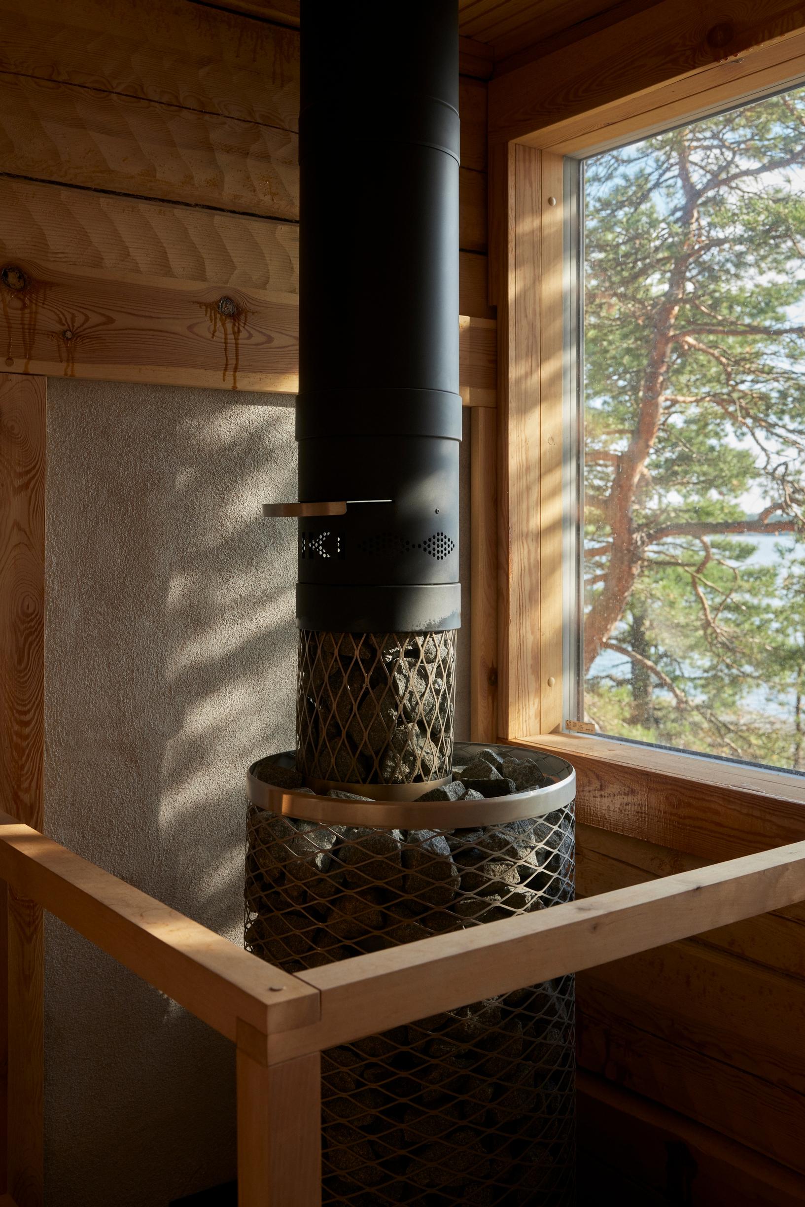 An Iki stove stands before a panoramic window.