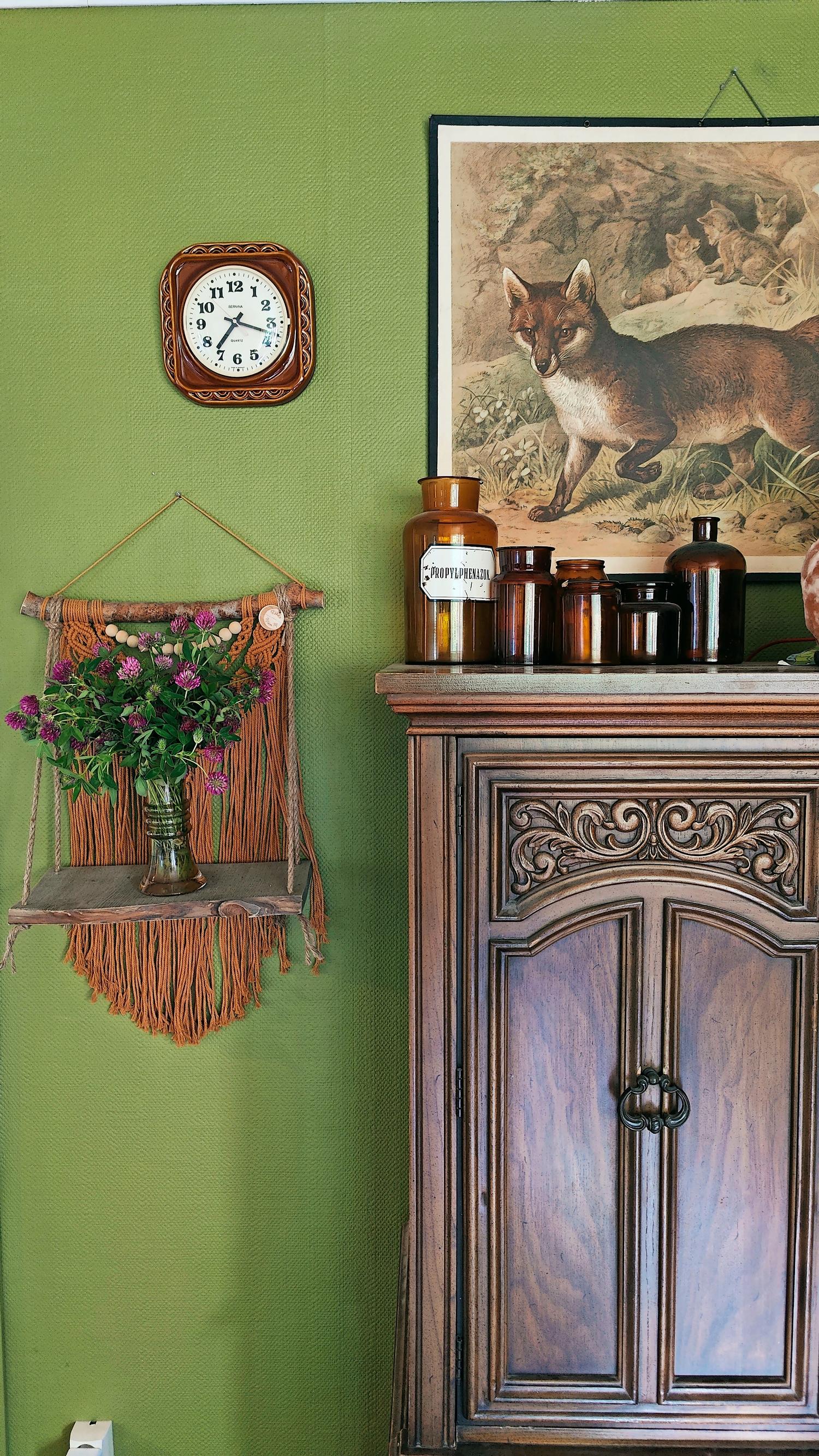 apothecary bottles and an educational poster on top of an old cabinet