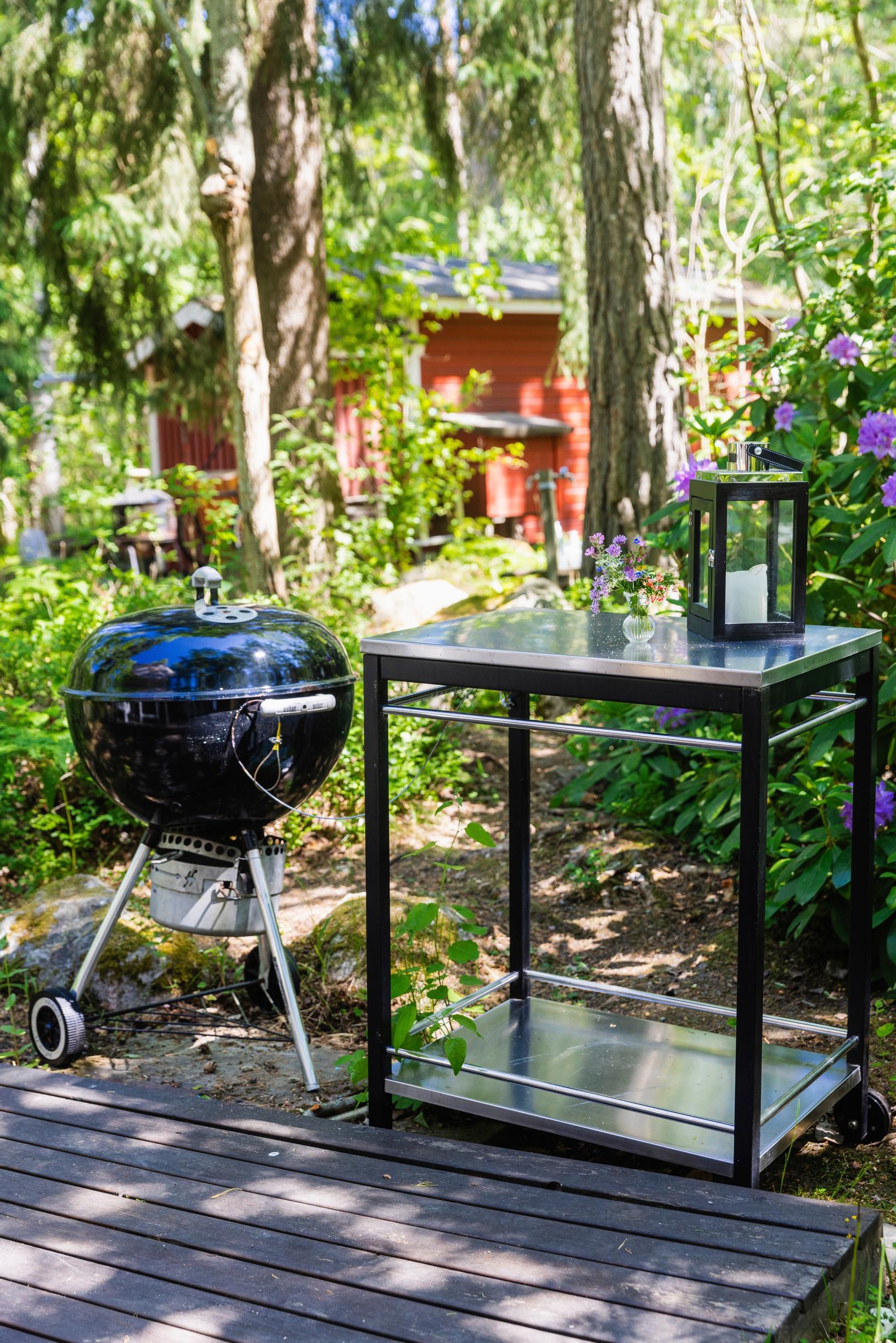 a kettle grill, lantern, and serving cart