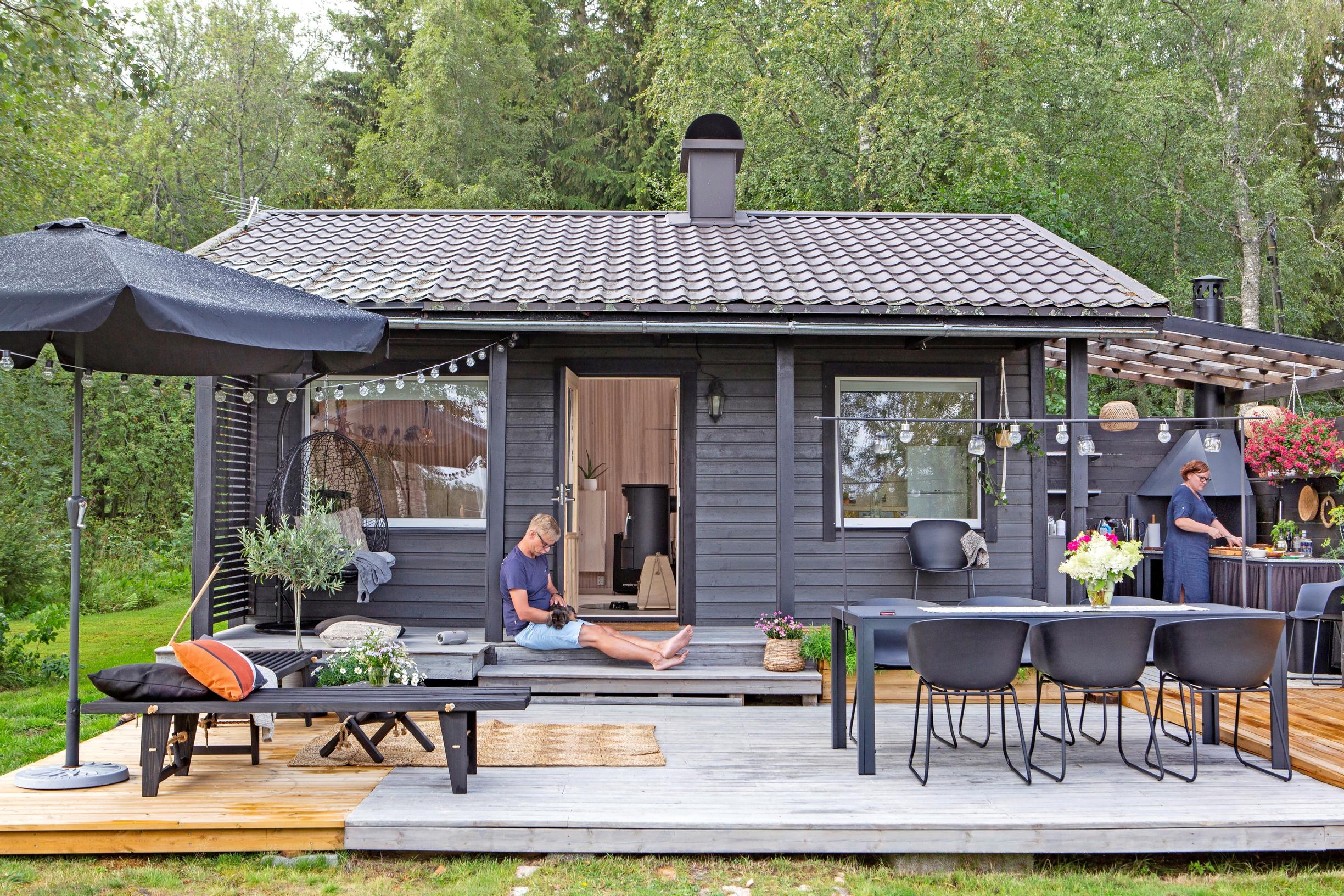 A terrace seating area formed by two L-shaped wooden benches