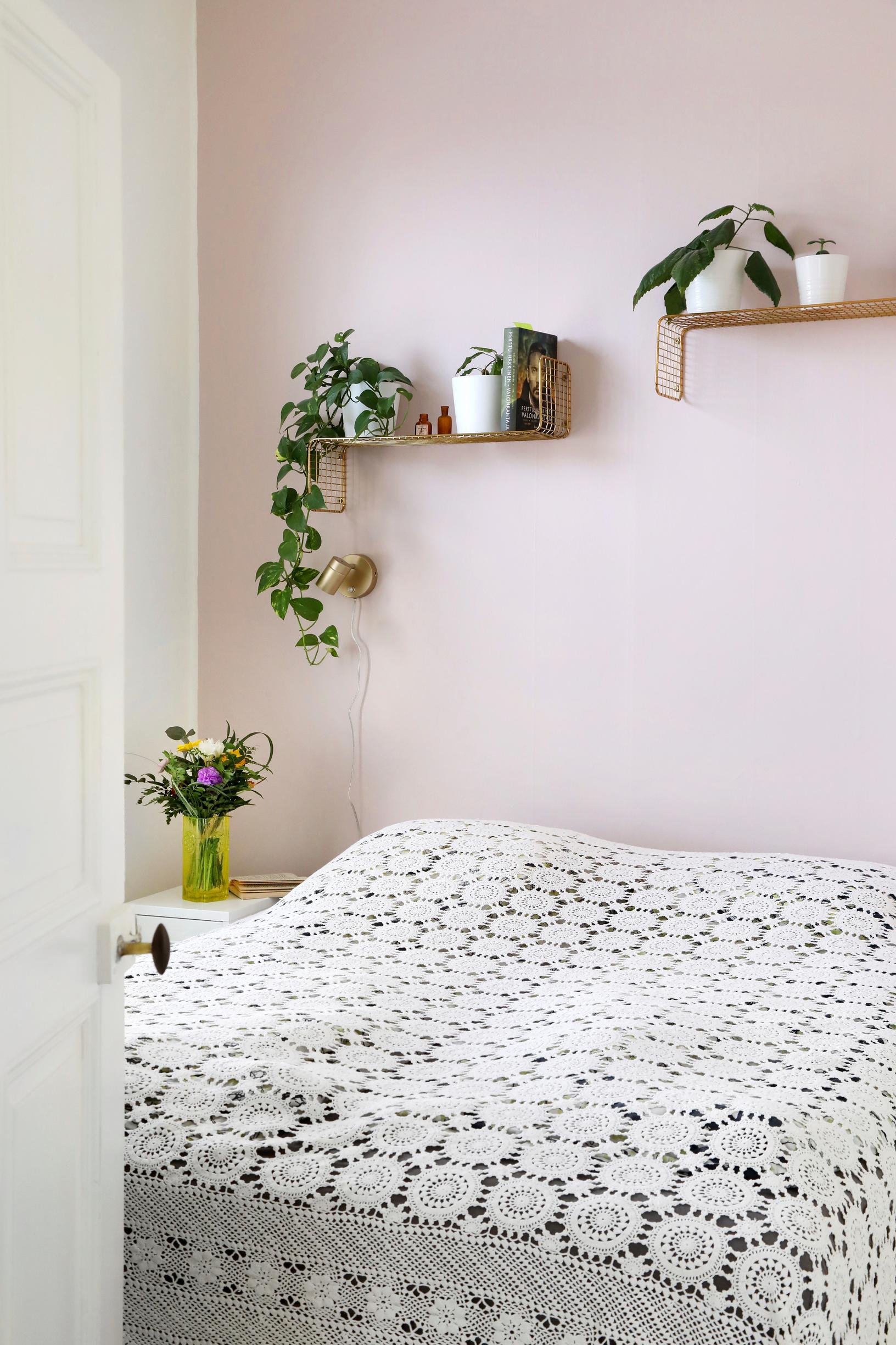 In the parents’ bedroom, the bed is covered by a delicate lace bedspread.
