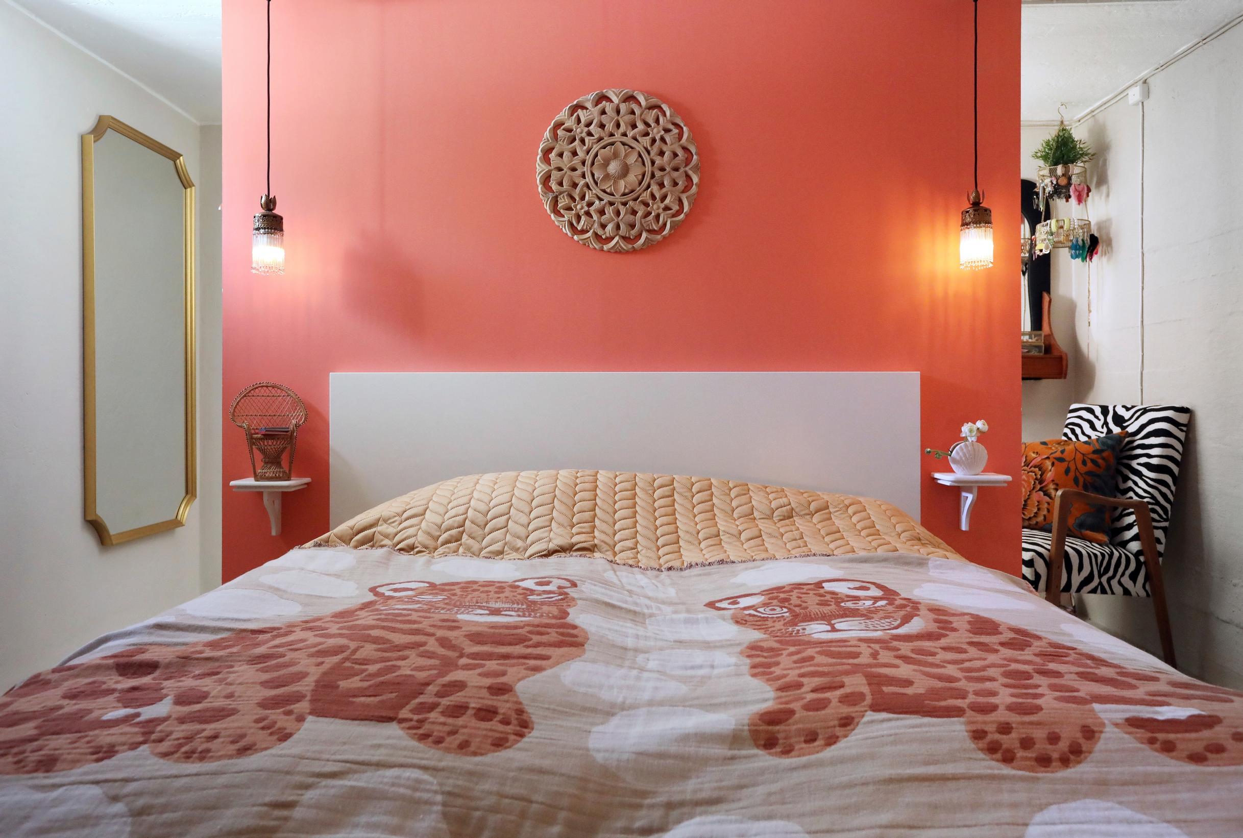 The bedroom’s flamingo-colored wall.