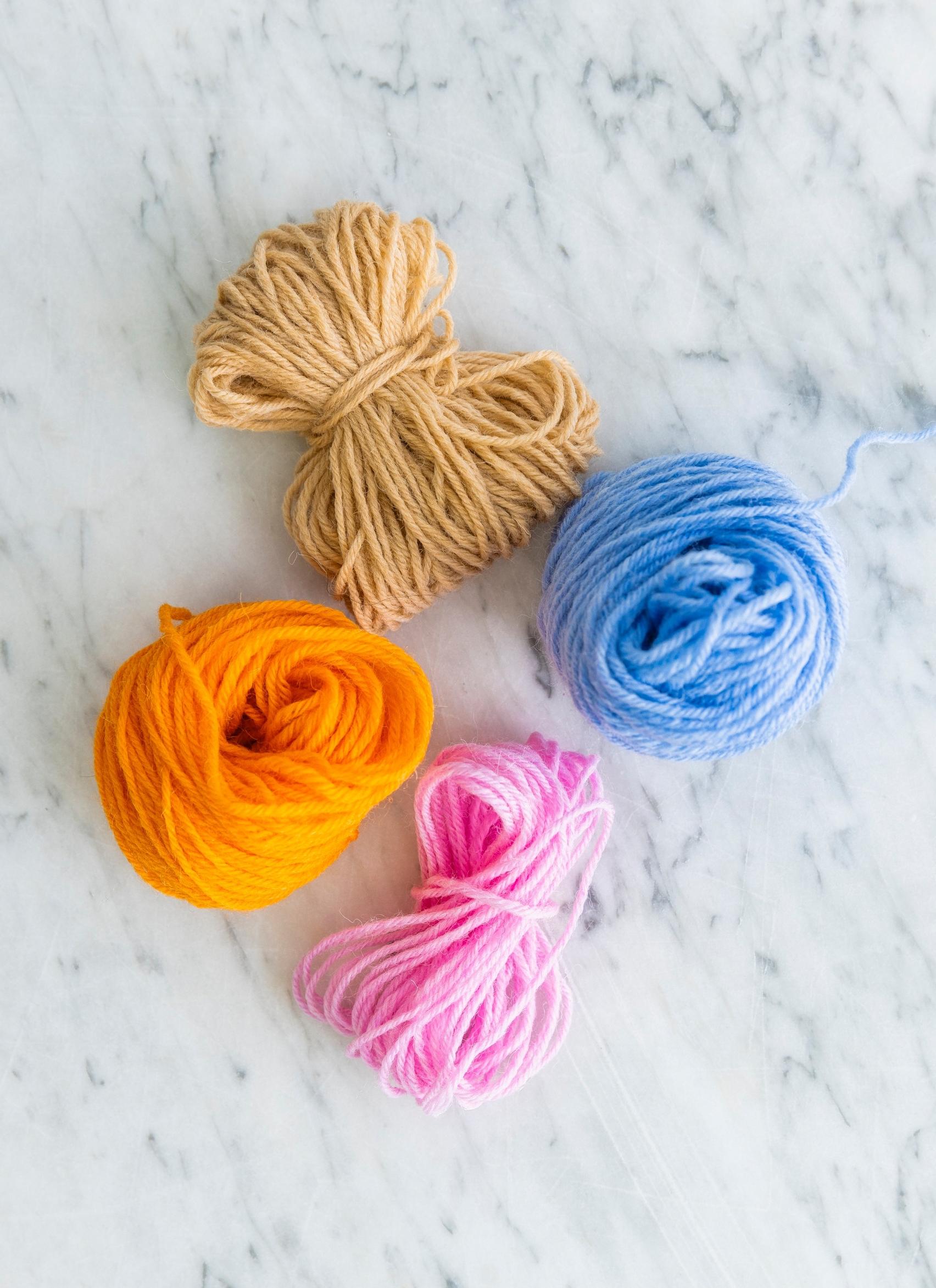 Rolls of leftover yarn in different colors.