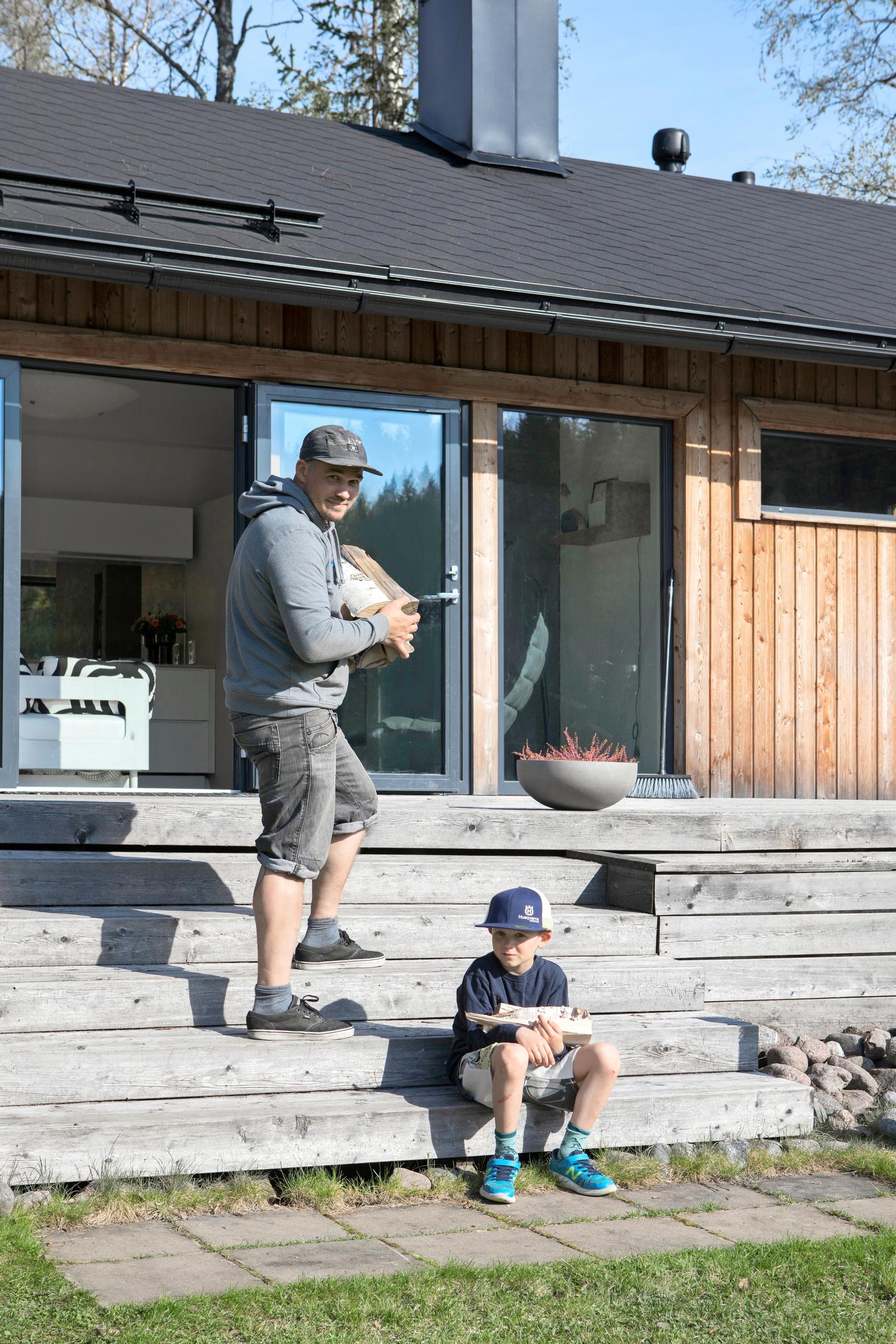 Father and son heating the sauna