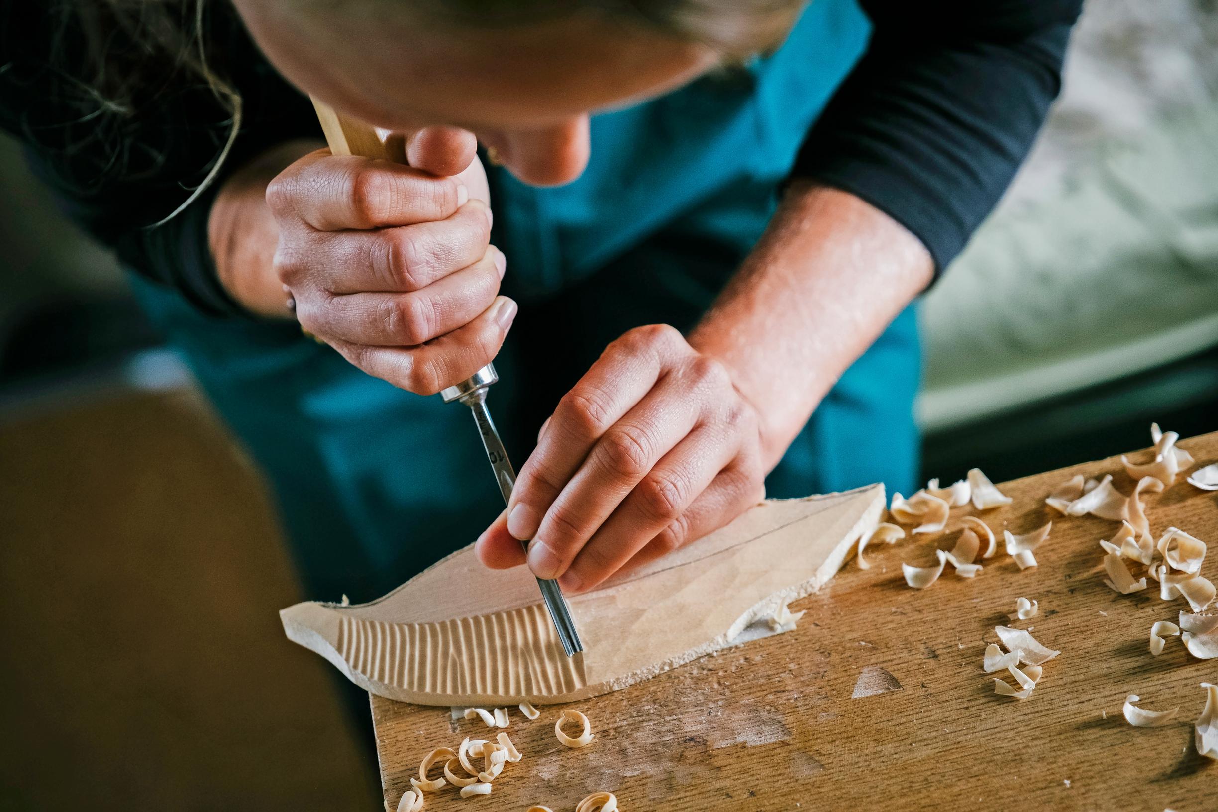 Close-up of a woman carving wood
