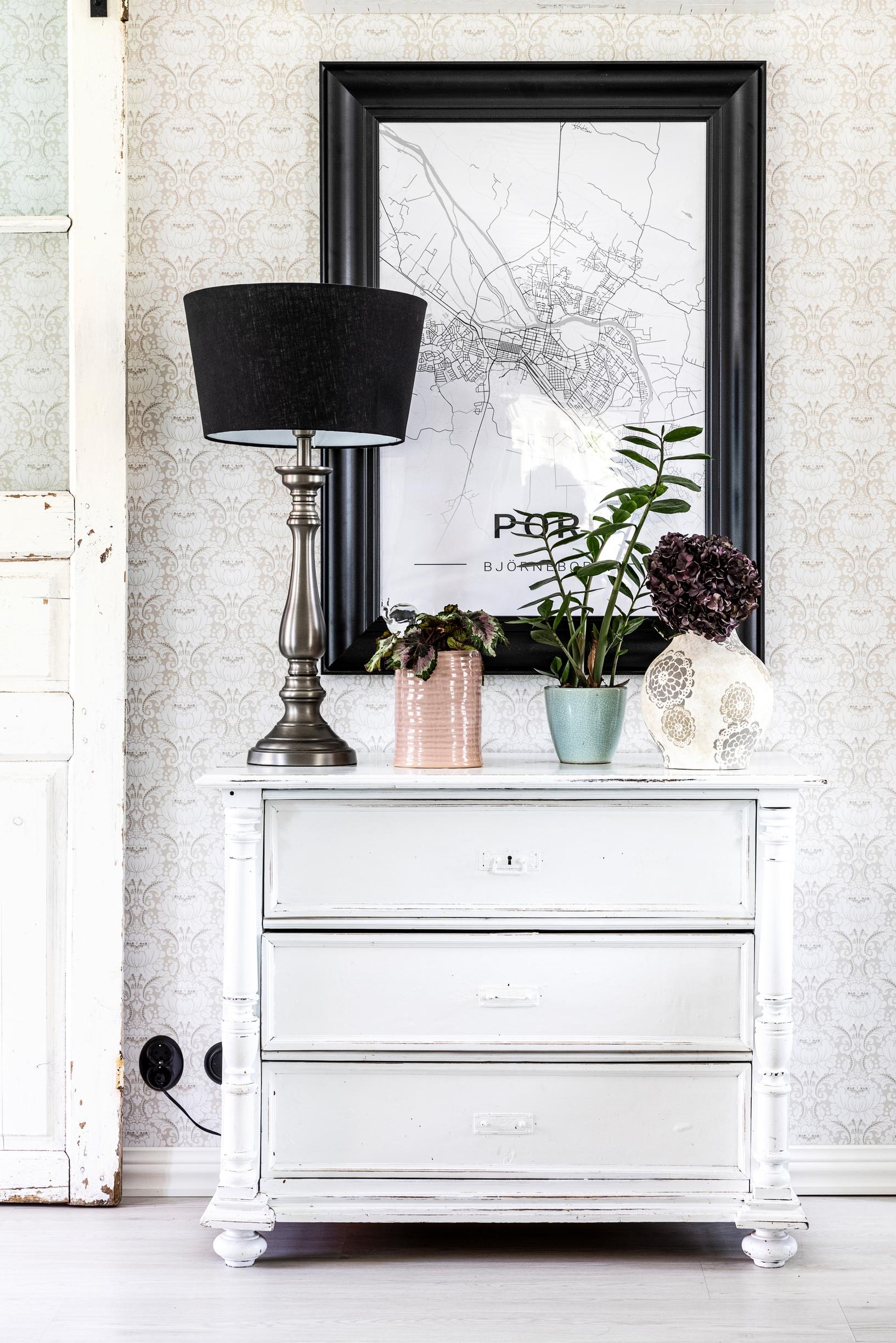 A white vintage dresser and a black-framed painting