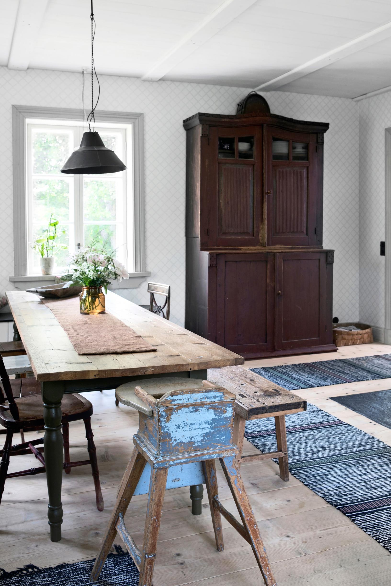 A large old dish cupboard and a long dining table