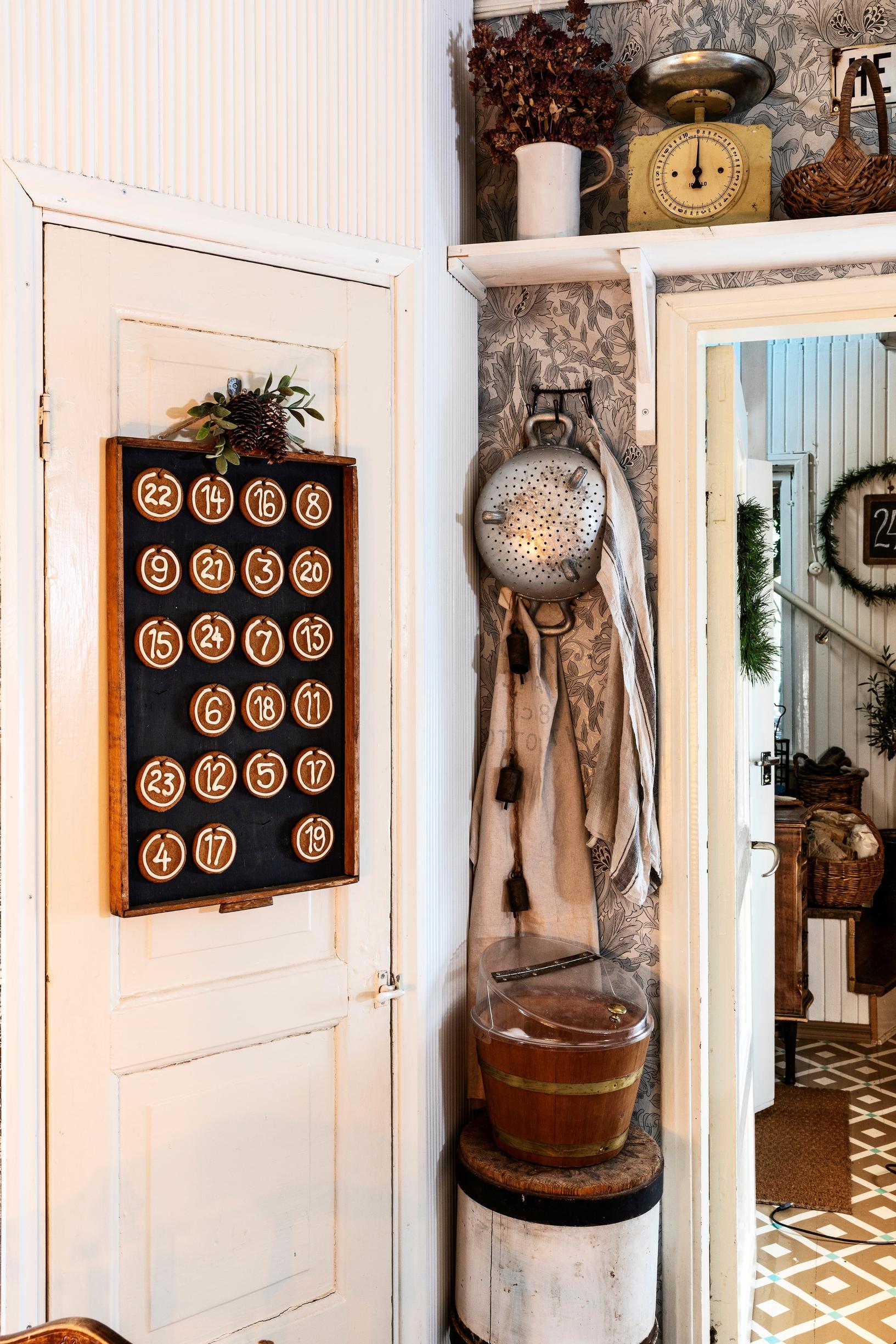A corner cabinet door decorated with a gingerbread advent calendar
