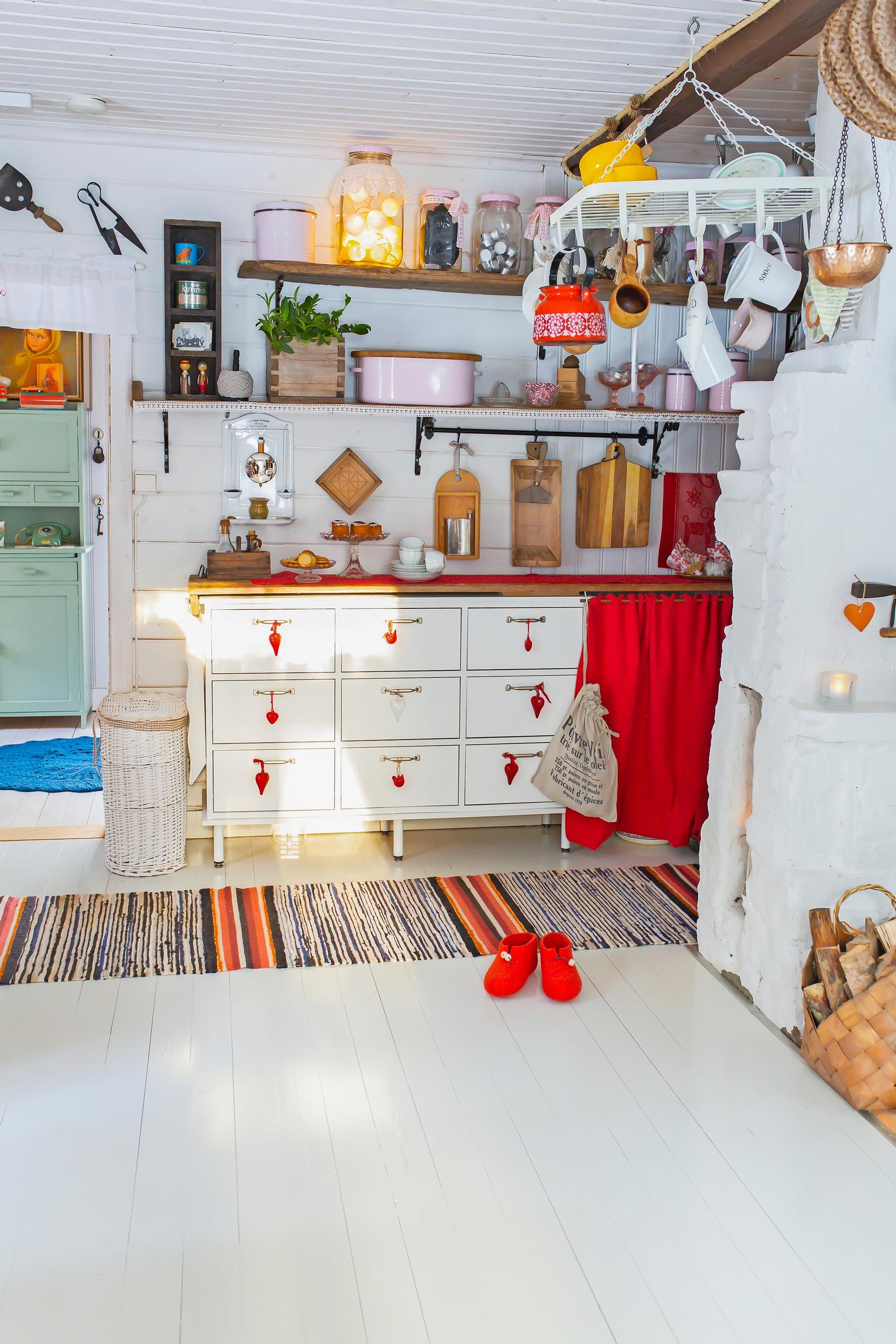 in the kitchen, items on the wall and shelf, a kitchen cabinet, and a plank floor