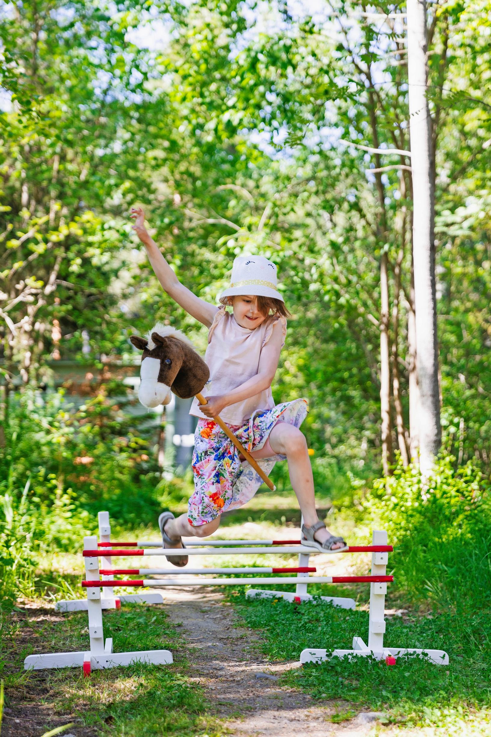 Matilda jumping a course with a hobbyhorse