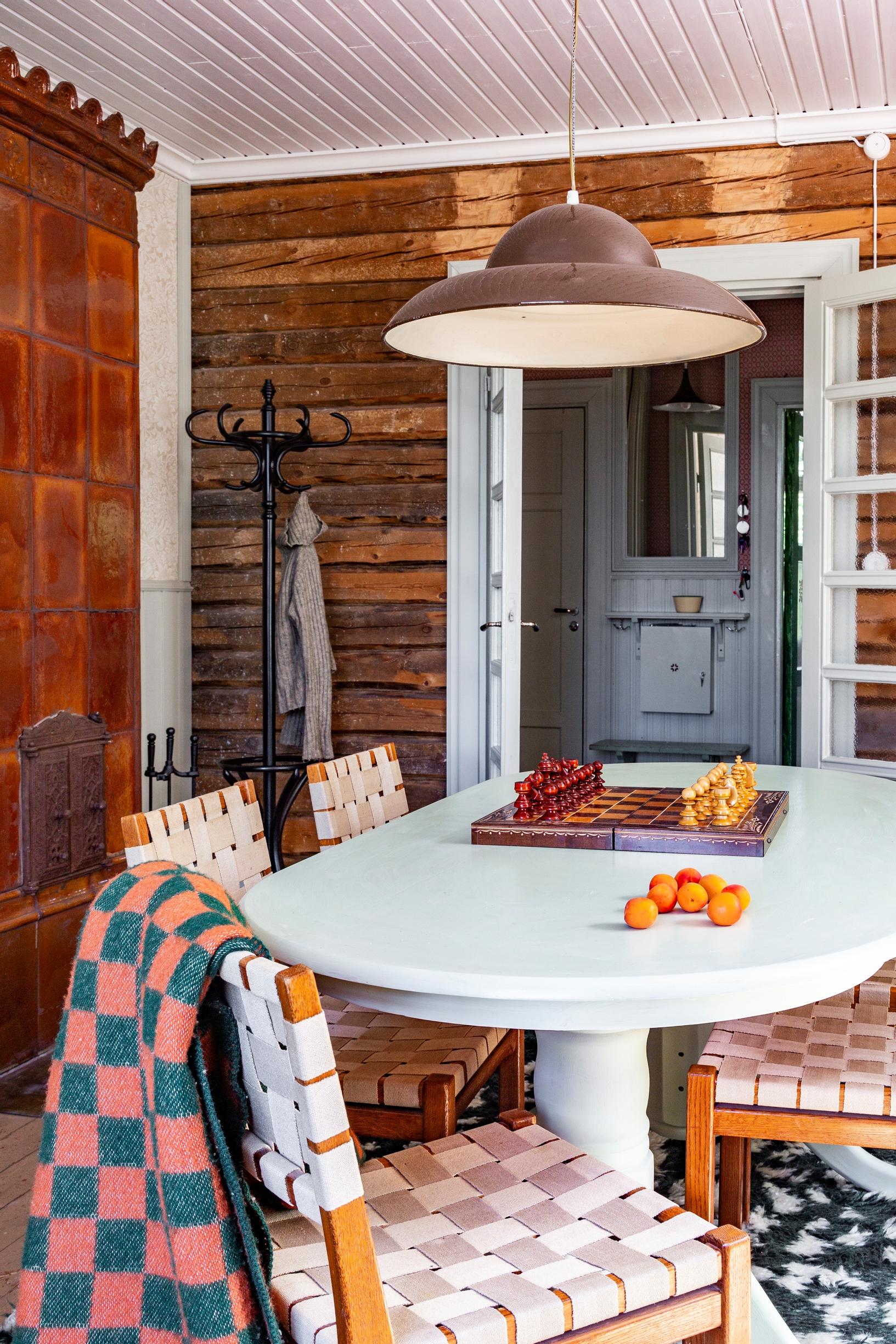 A tiled stove built from old tiles next to the dining area.