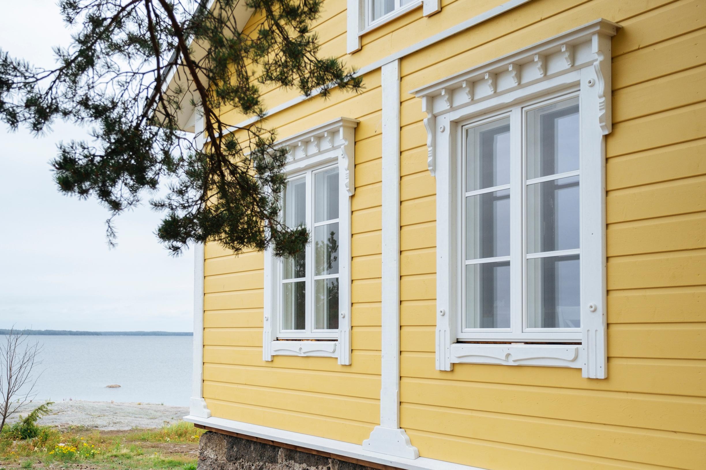 Yellow log house by the sea