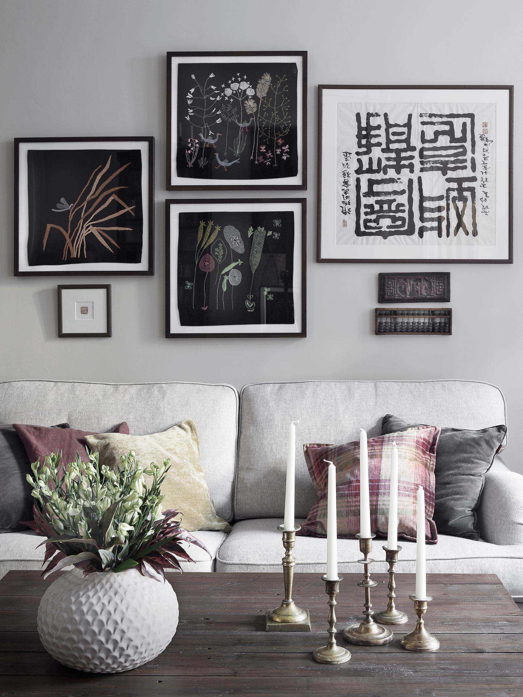 How high to hang art? An art collage above a sofa