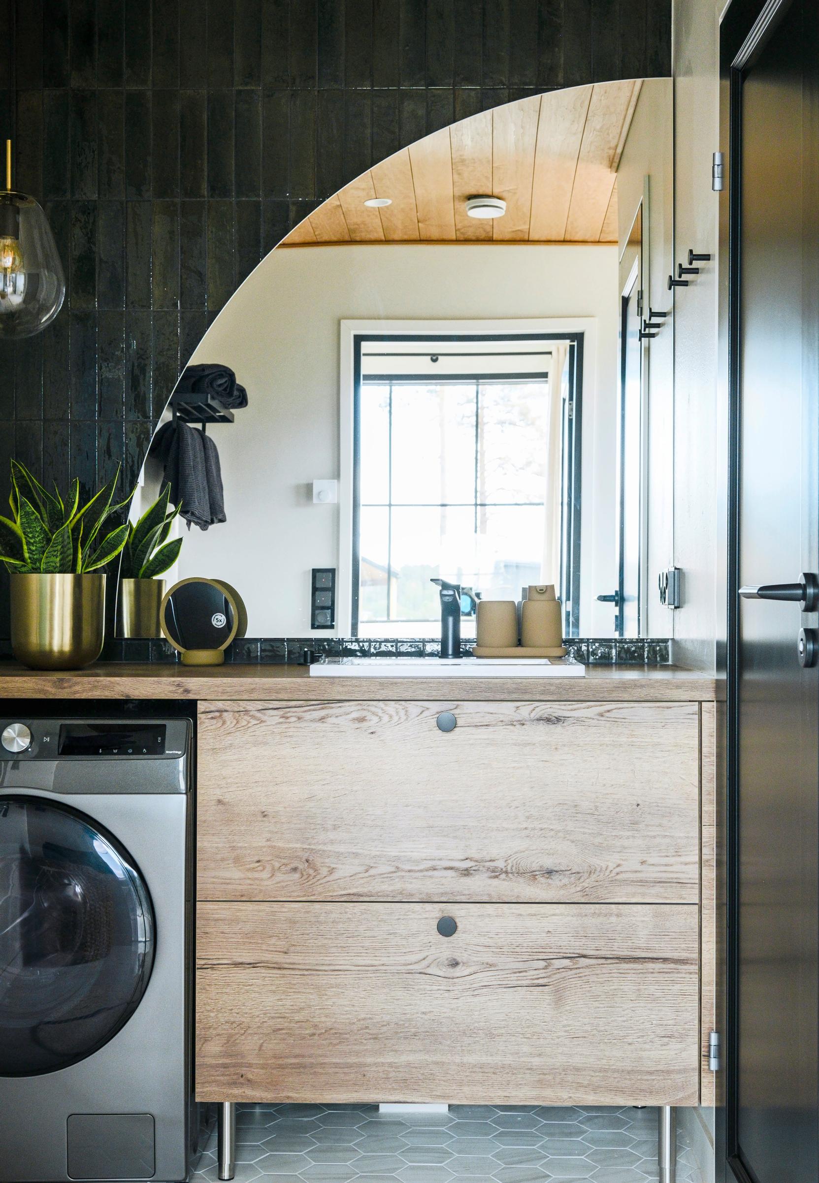 Tall cabinets and a vanity serve as storage in the bathroom.