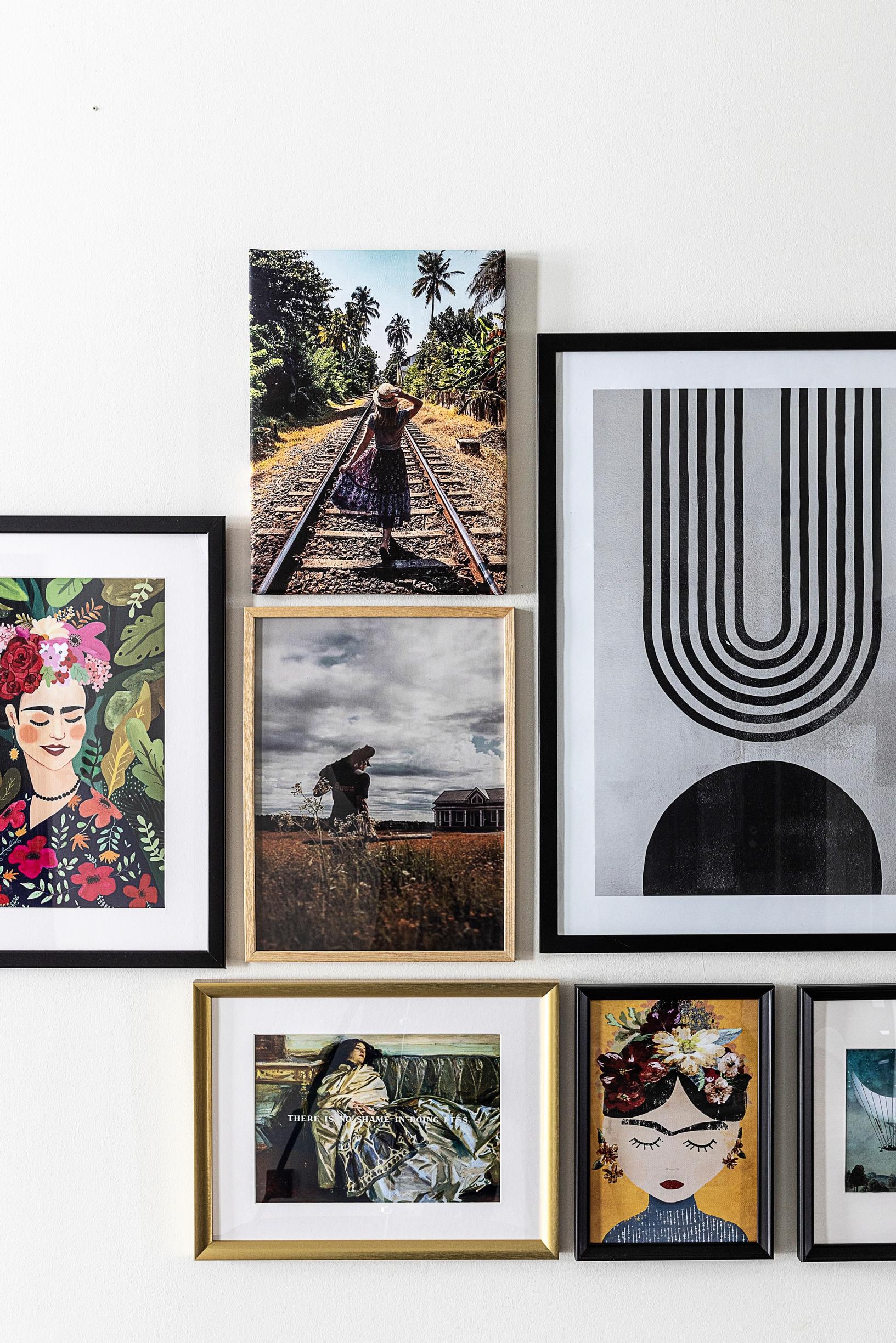 A collection of framed pictures on the wall.