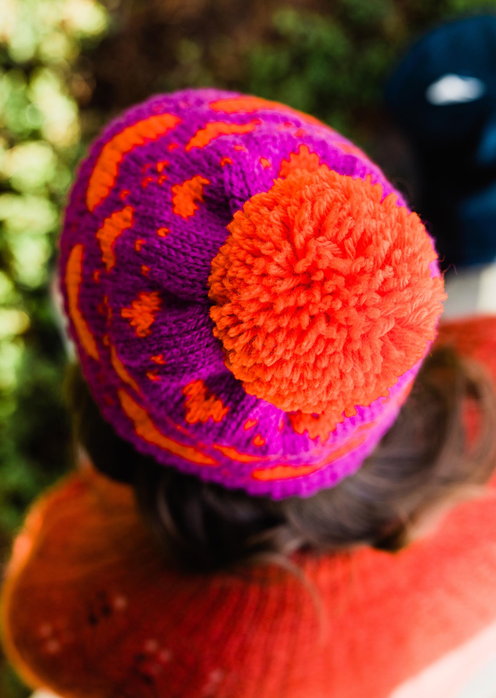 A hat decorated with a large pom-pom