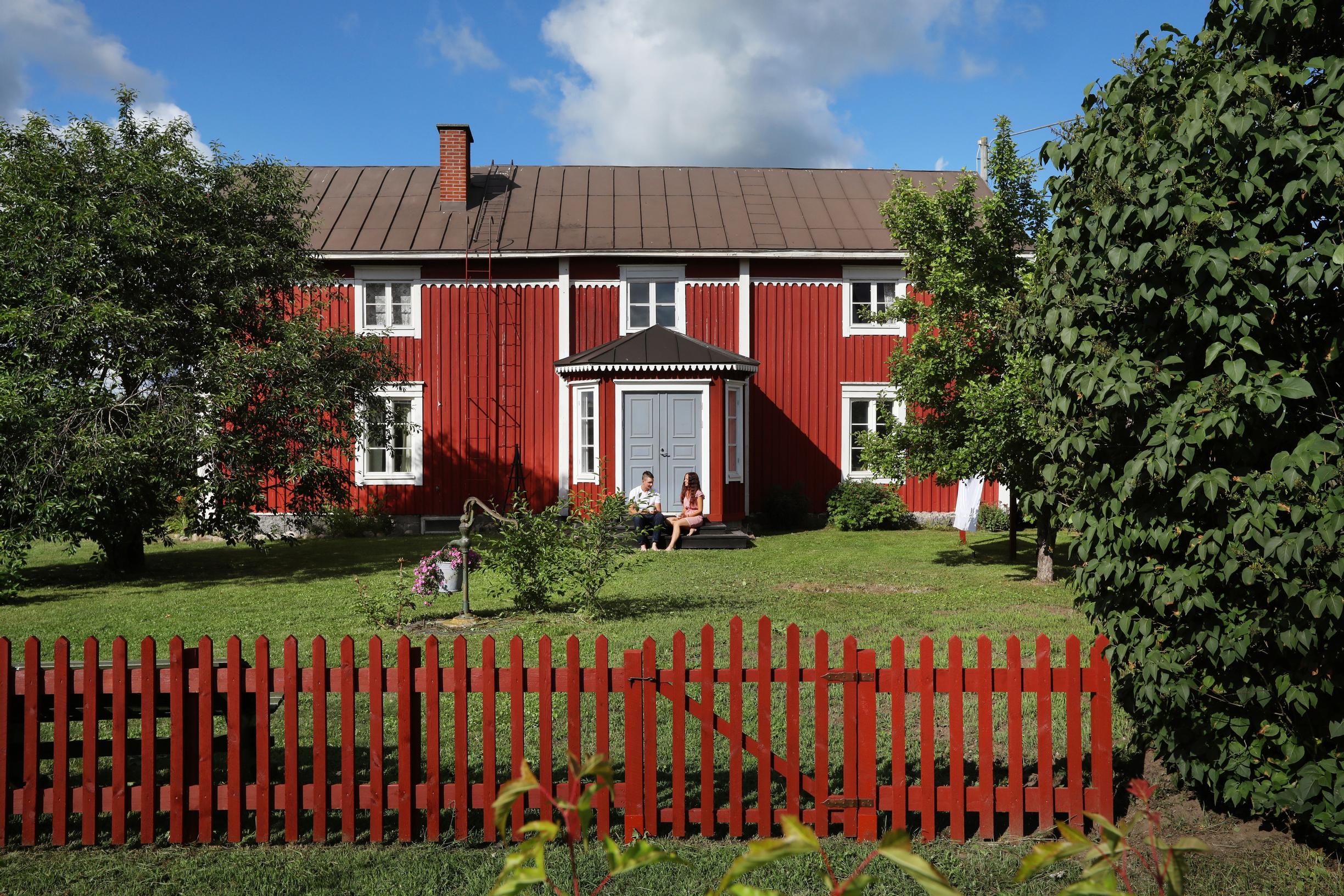Red Ostrobothnian house and wooden fence