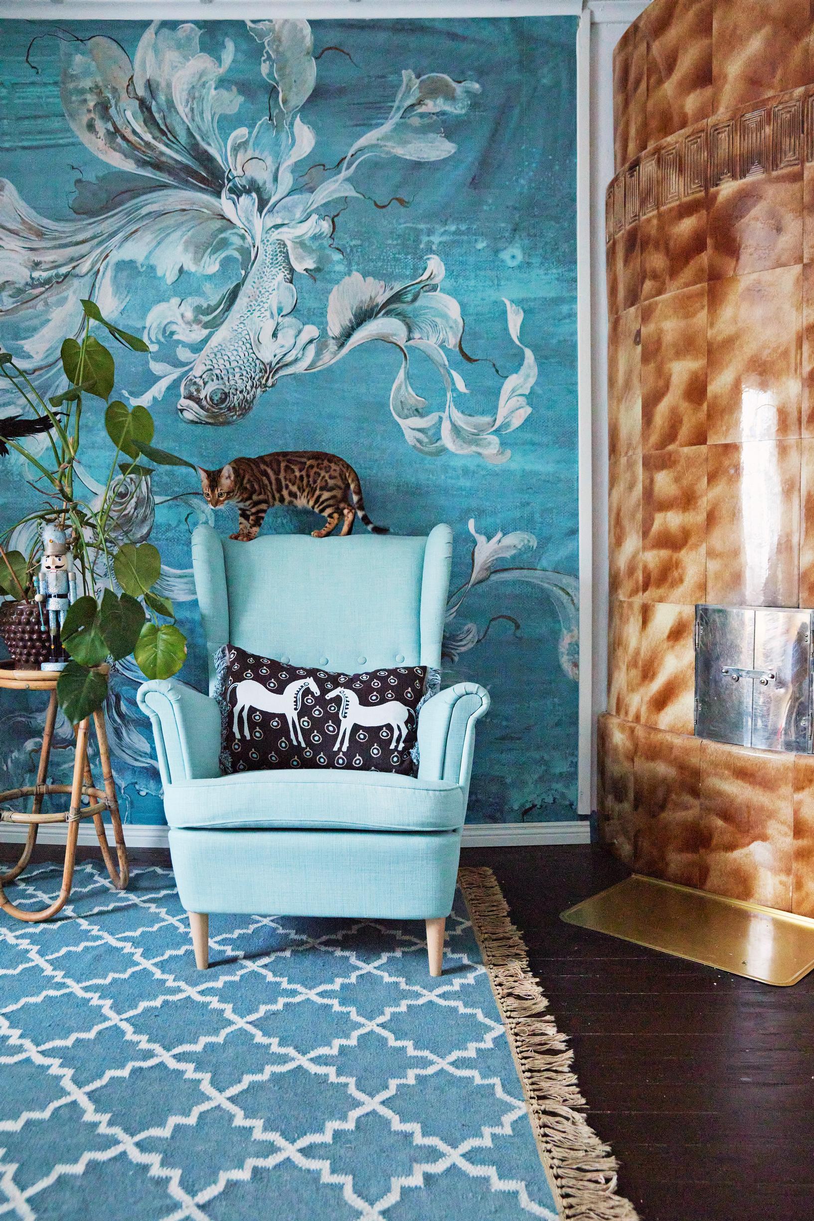 A turquoise armchair and rug