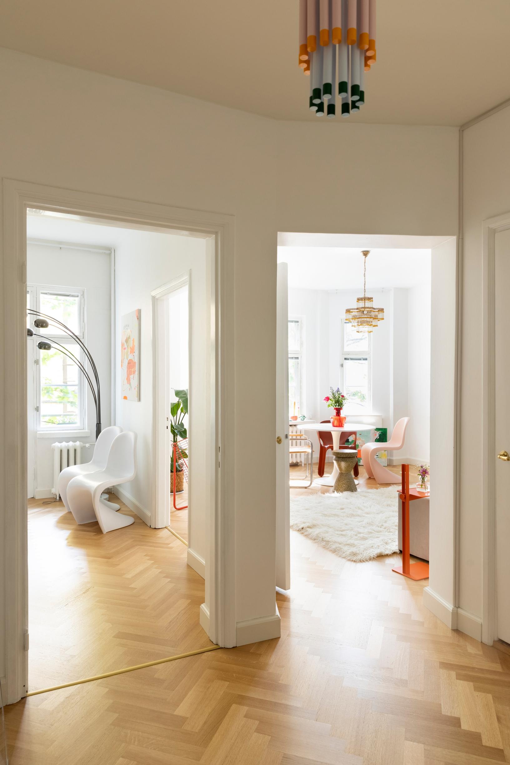 A view into two rooms, each with the same herringbone parquet.