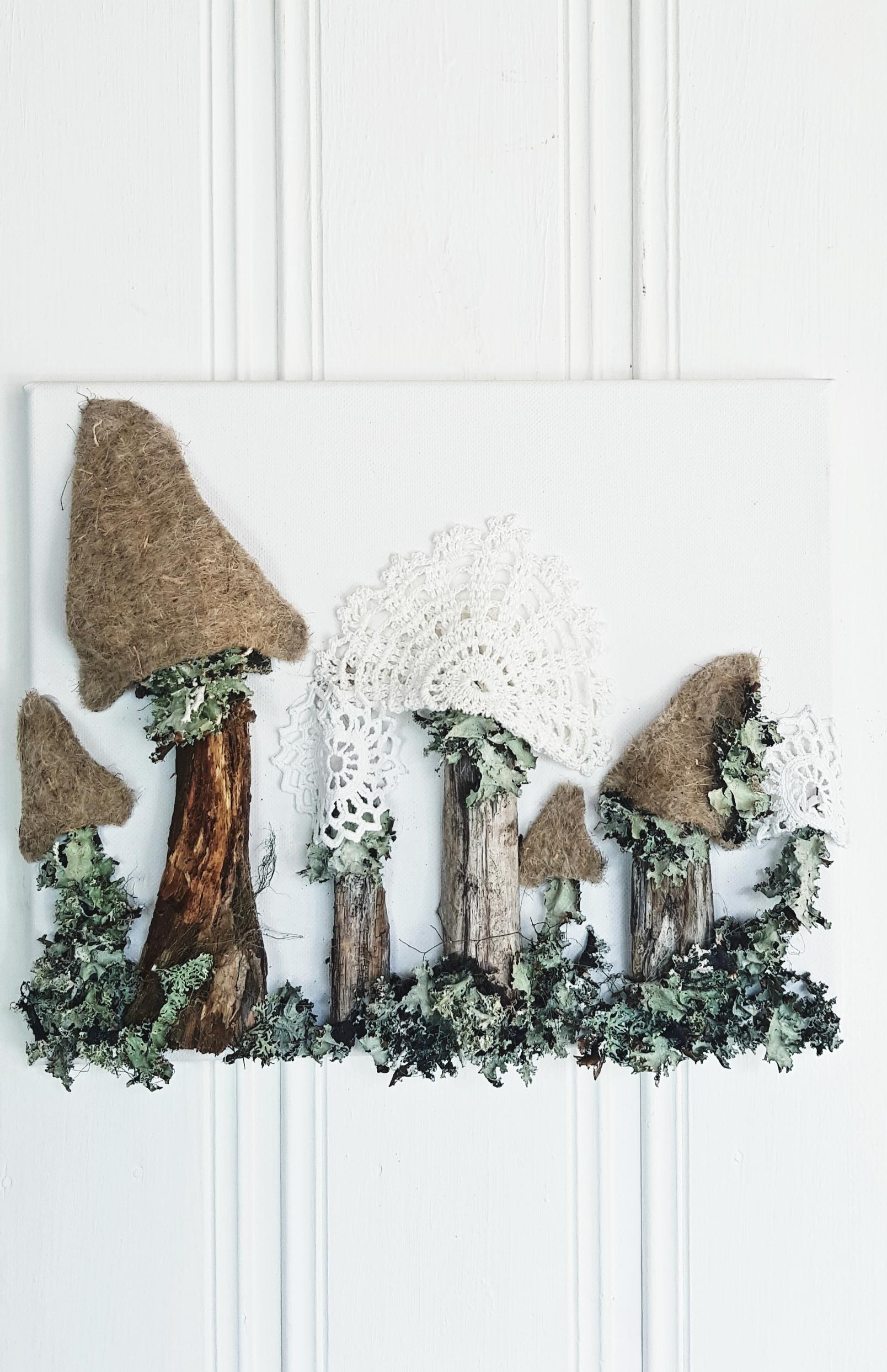 The mushroom shapes are made from pieces of branch, felt, and lace doilies.