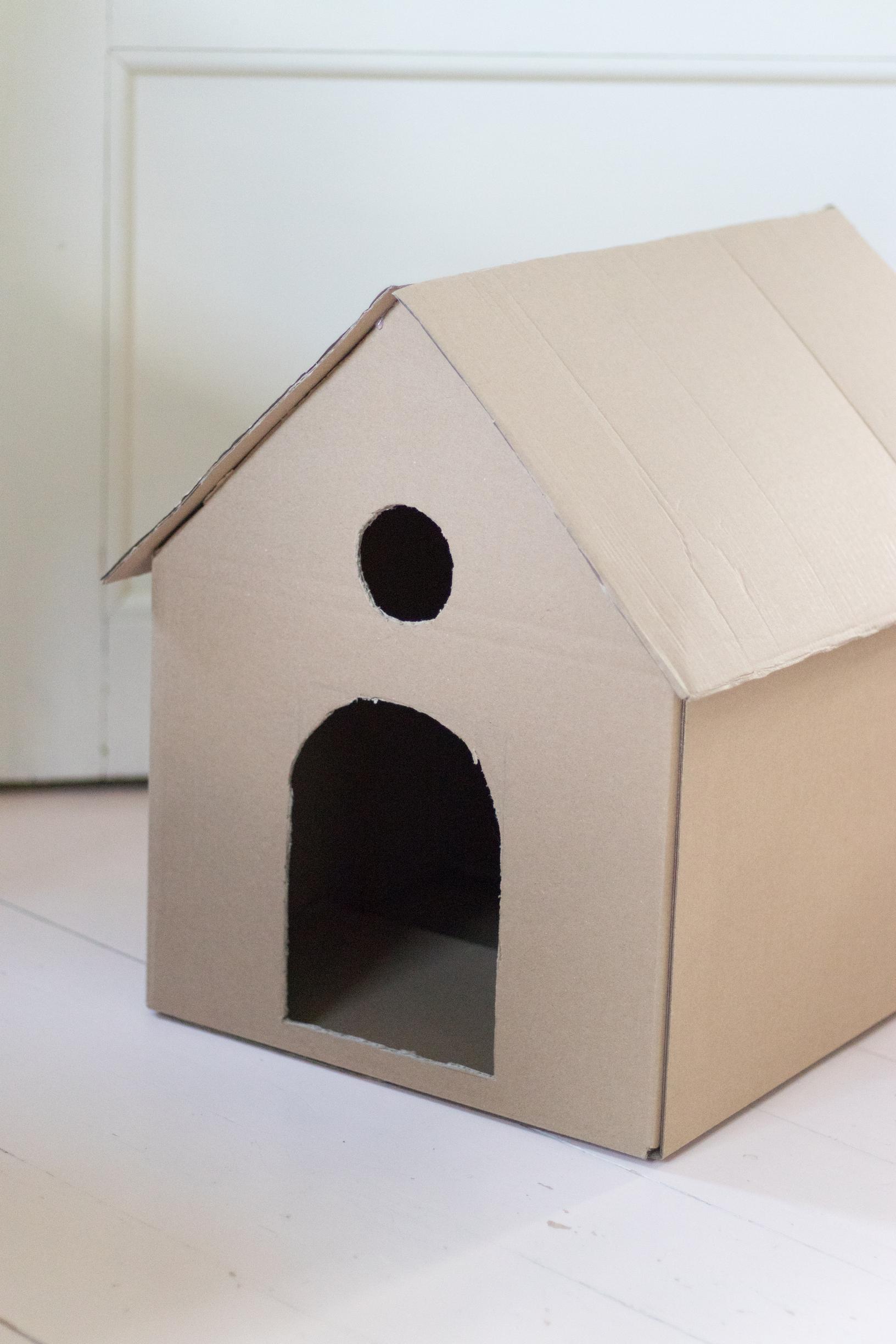 Cardboard box with door and window openings cut out