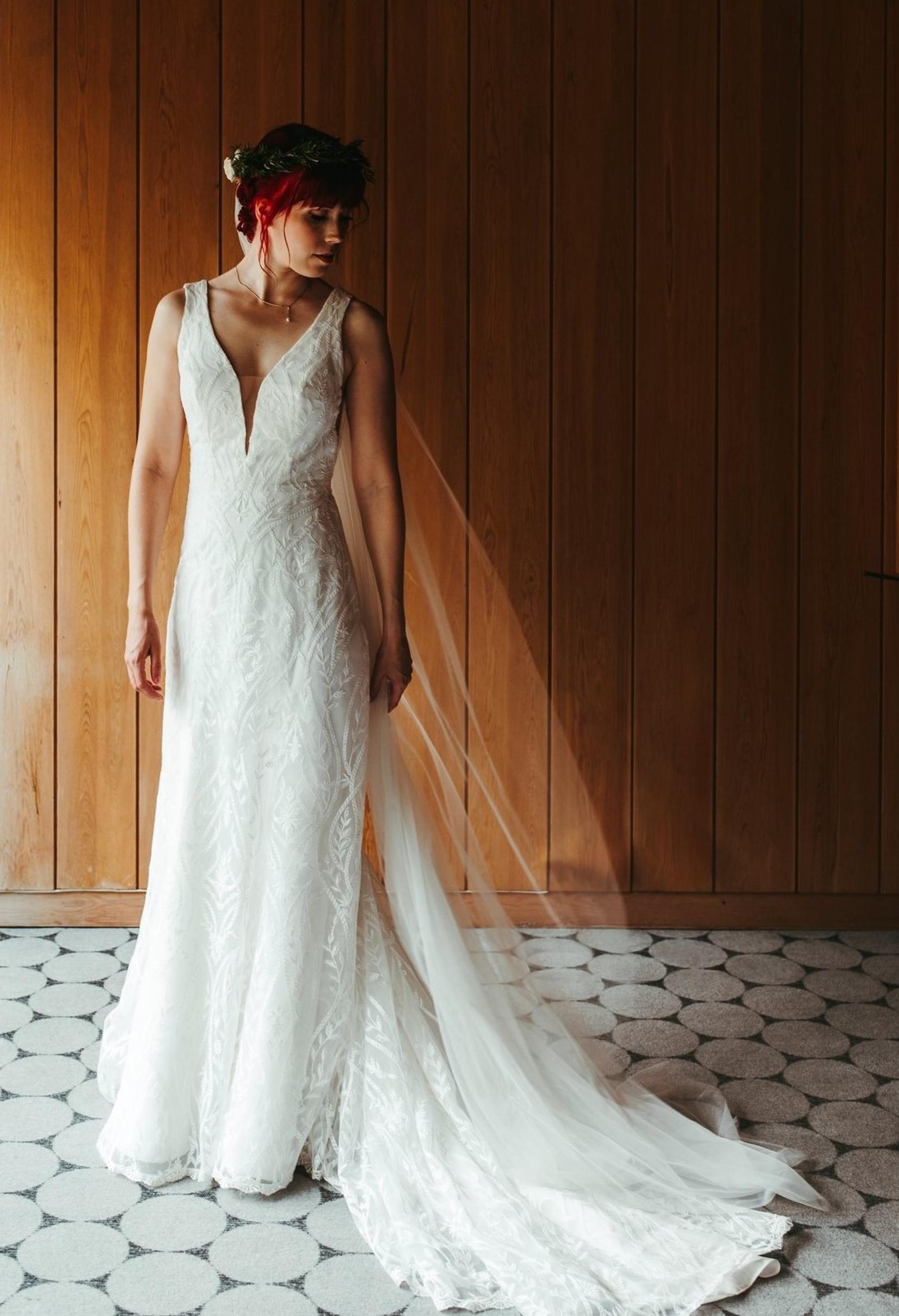 Emma stands in her dress, ready for the celebration.