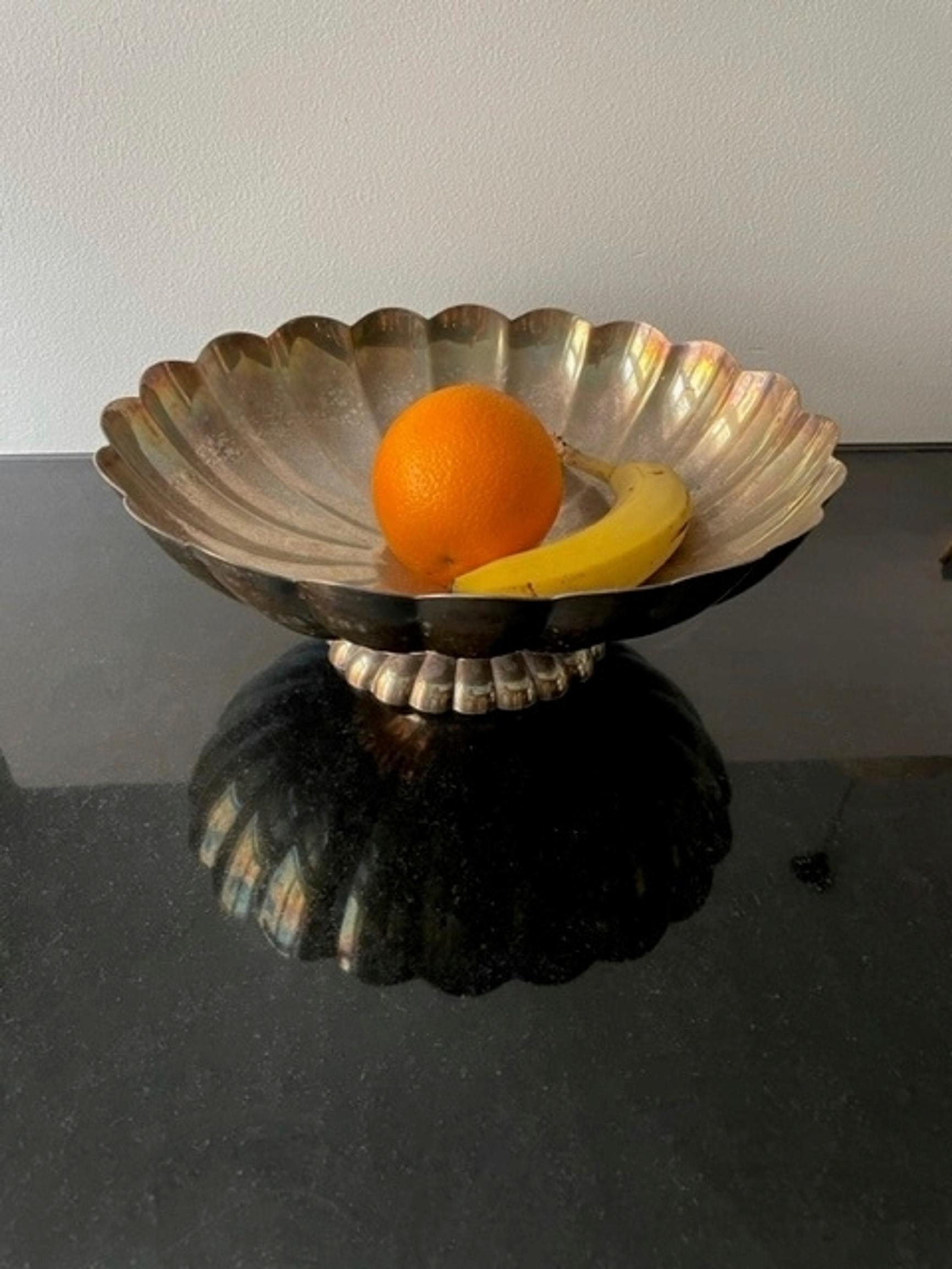 A metal bowl filled with fruit