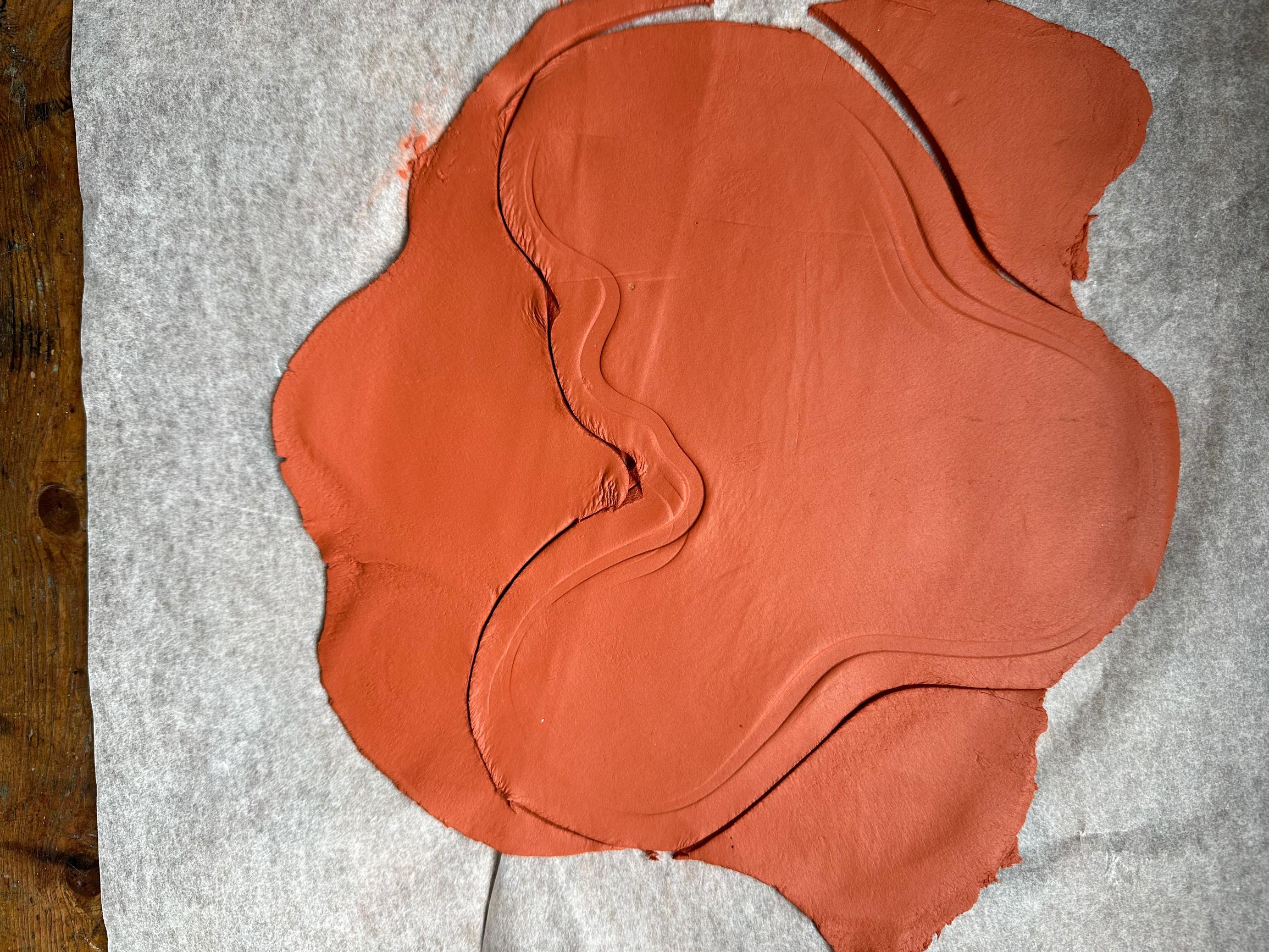 The vase shape has been pressed into air-dry clay.