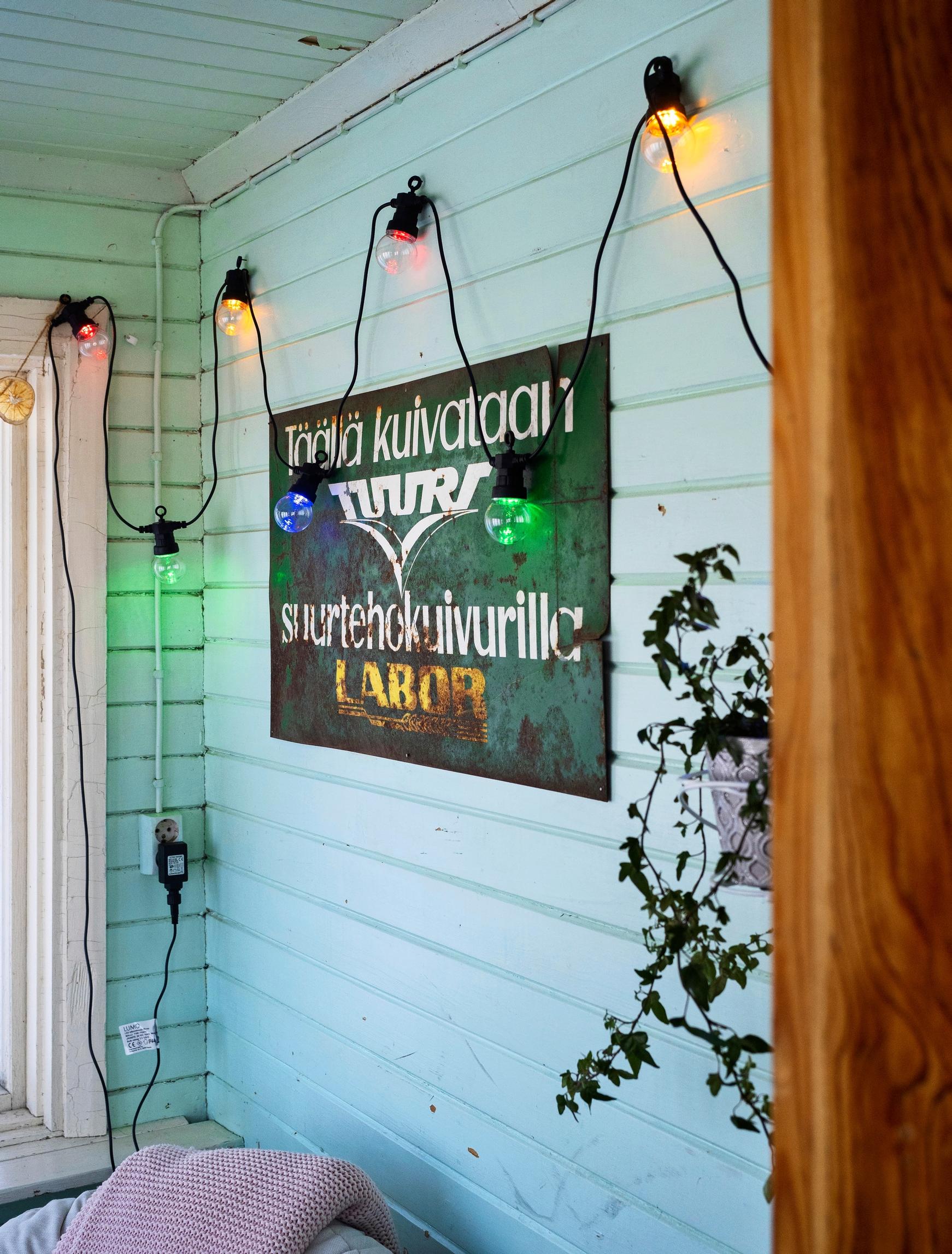 A photo of the veranda with a sign on the wall