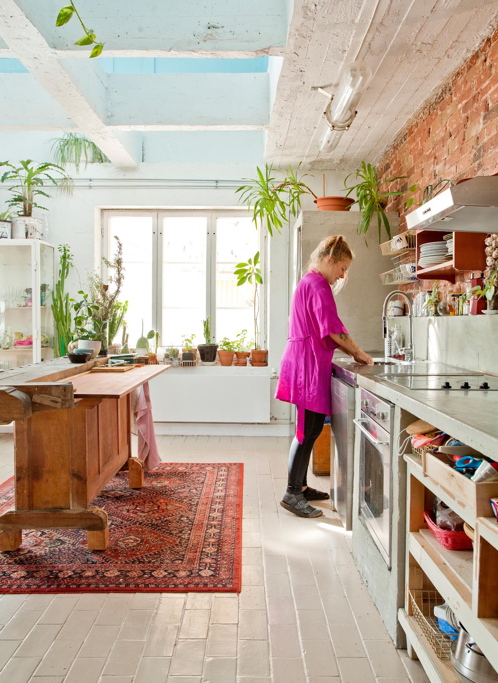 A workbench as the island and a concrete countertop cast on-site in the kitchen