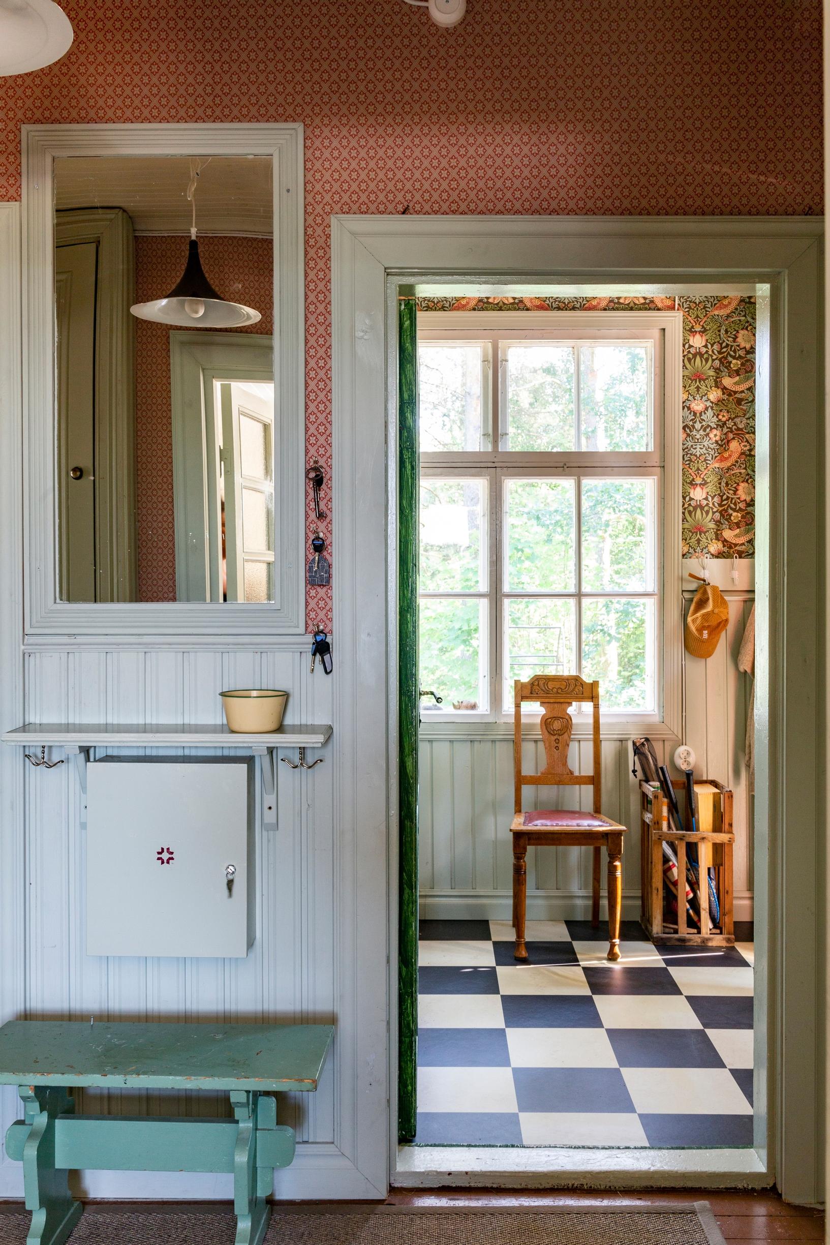 Patterned wallpaper and checkered floor on the veranda.