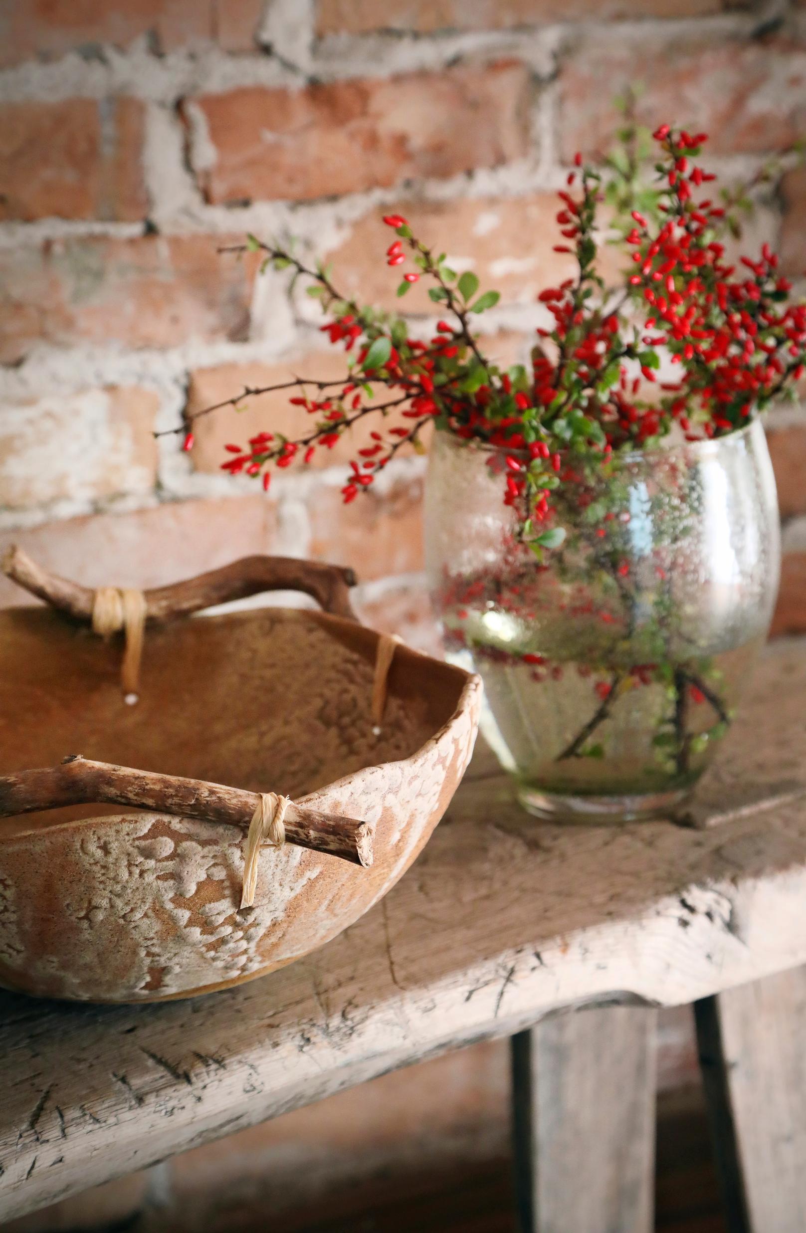 A bowl made by Nina Kiuru. Behind it, a brick wall.